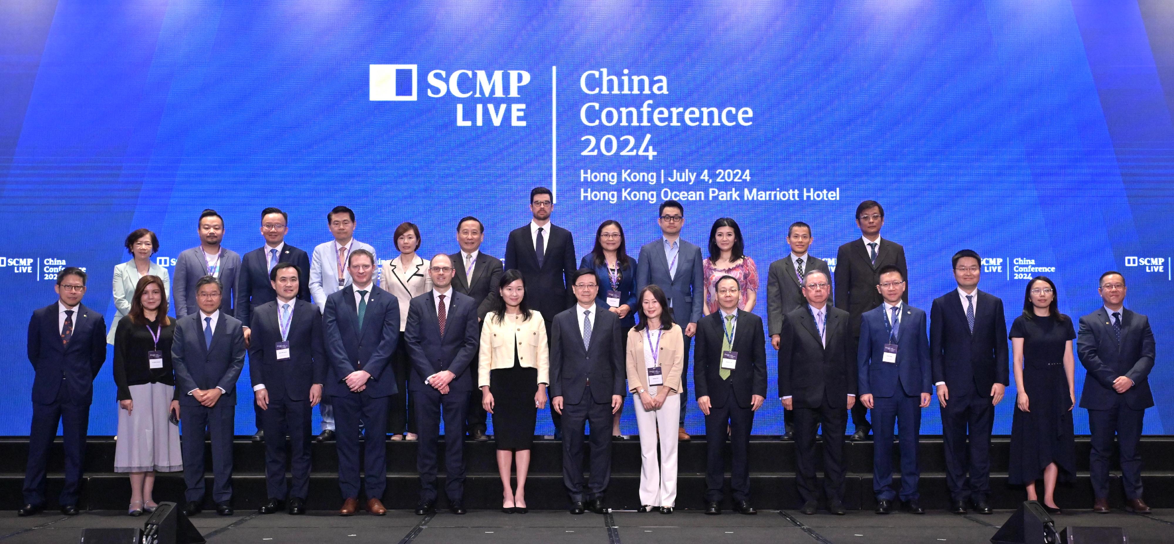 The Chief Executive, Mr John Lee, attended the South China Morning Post China Conference 2024 today (July 4). Photo shows (front row, from sixth left) the President and Chief Executive Officer of Manulife Asia, Mr Phil Witherington; the Chief Executive Officer of the South China Morning Post (SCMP), Ms Catherine So; Mr Lee; the Editor-in-Chief of the SCMP, Ms Tammy Tam, and other guests at the conference.
