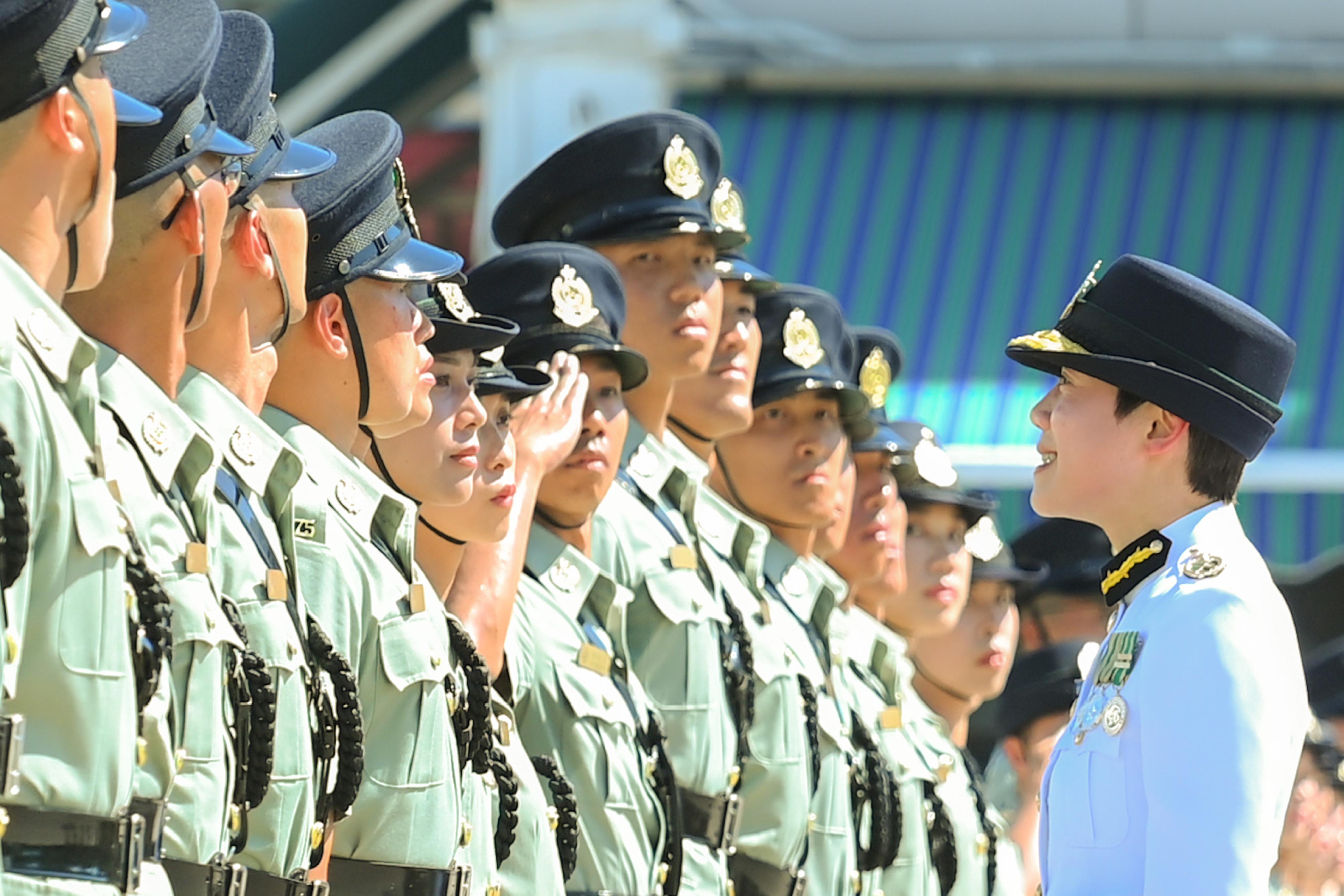 The Commissioner of Customs and Excise, Ms Louise Ho (first right), inspects passing-out officers at the Hong Kong Customs Passing-out Parade today (July 5).