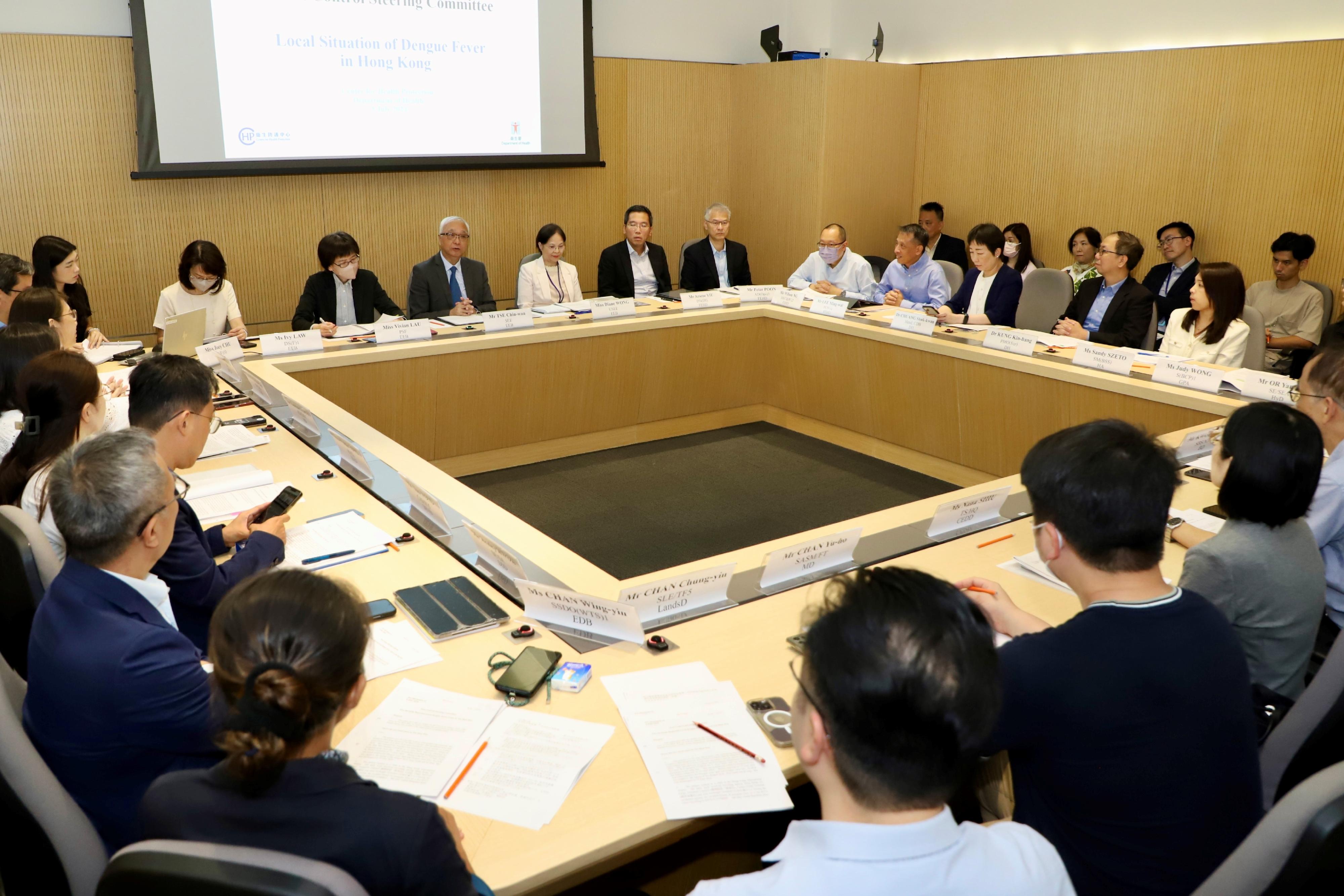 The interdepartmental Pest Control Steering Committee convened a special meeting today (July 5) to discuss the implementation of further measures to prevent the spread of local dengue fever cases. The Secretary for Environment and Ecology, Mr Tse Chin-wan (fourth left), and the Under Secretary for Environment and Ecology, Miss Diane Wong (fifth left), attended the meeting. Participants at the meeting came from three policy bureaux and 20 government departments and organisations.