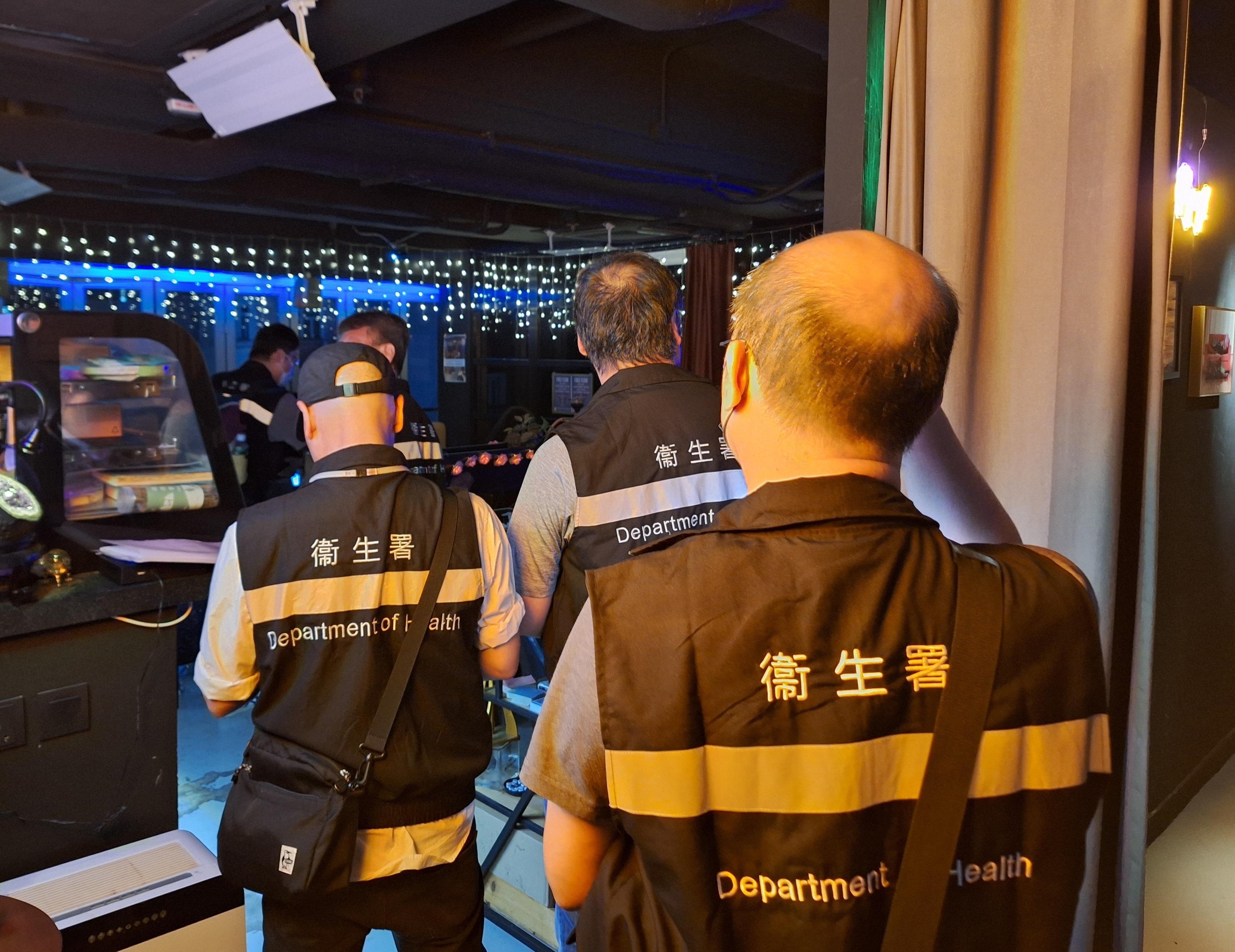 The Tobacco and Alcohol Control Office (TACO) of the Department of Health conducted an enforcement operation against illegal waterpipe smoking activities in no smoking areas in Wan Chai during the evening of July 6. Photo shows officers from TACO taking enforcement action inside the bar.