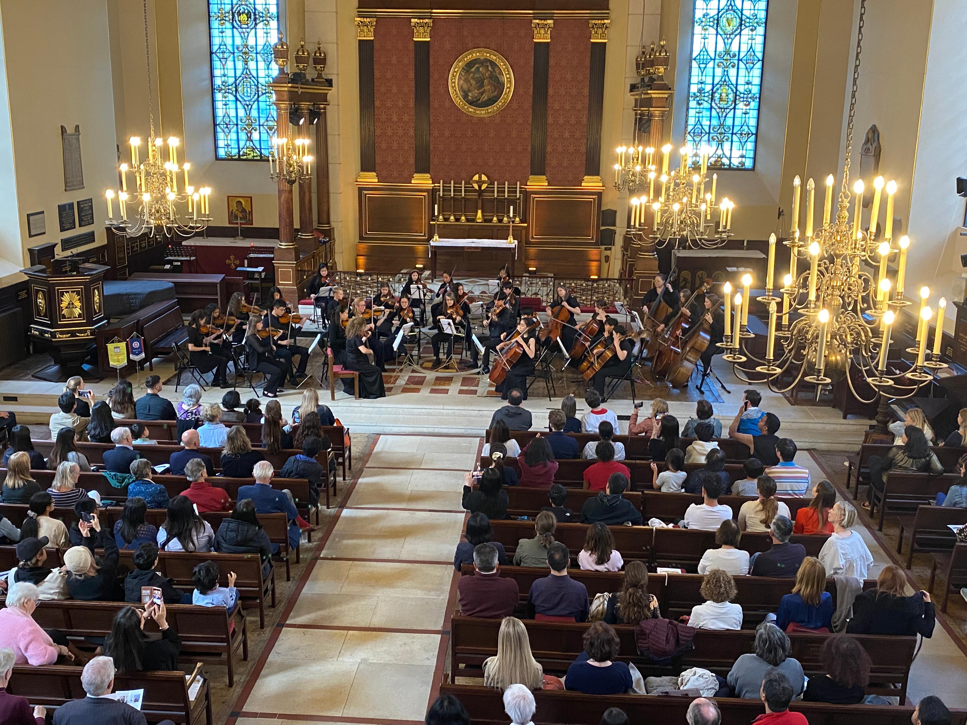 The Hong Kong Economic and Trade Office, London supported the Musicus Society's cultural exchange tour in partnership with the English Chamber Orchestra from July 3 to 9, 2024 (London time). Photo shows the tour members performing a string ensemble with local students and musicians at the historic St. Paul's Church at Covent Garden, London, in the evening of July 7.  