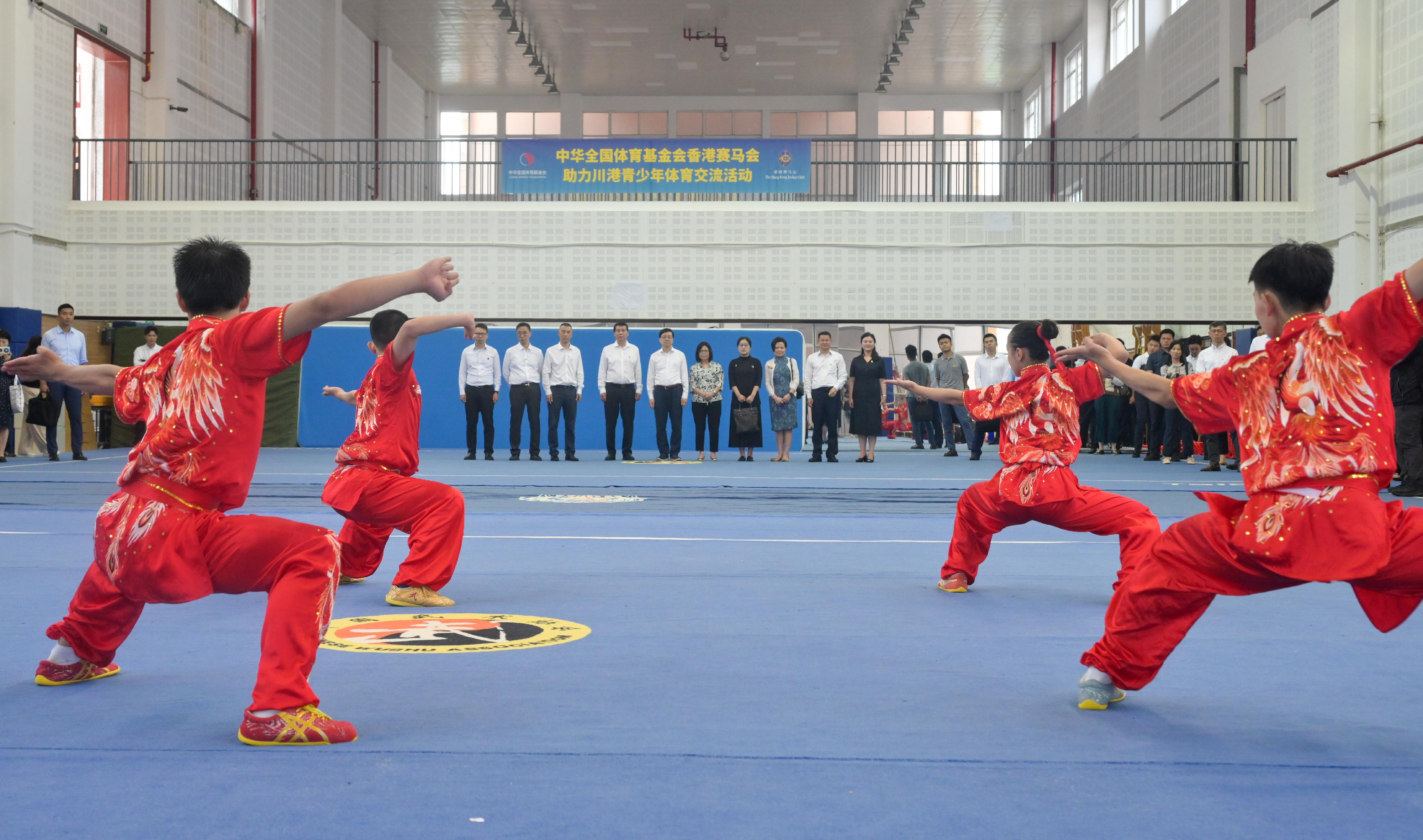 The Chief Executive, Mr John Lee, and his wife Mrs Janet Lee started their visit to Sichuan today (July 8). Photo shows Mr Lee and his wife Mrs Lee (fifth left and fifth right); the Secretary for Culture, Sports and Tourism, Mr Kevin Yeung (second left), and other officials visiting the Sichuan HKJC Olympic School and watching a wushu performance.