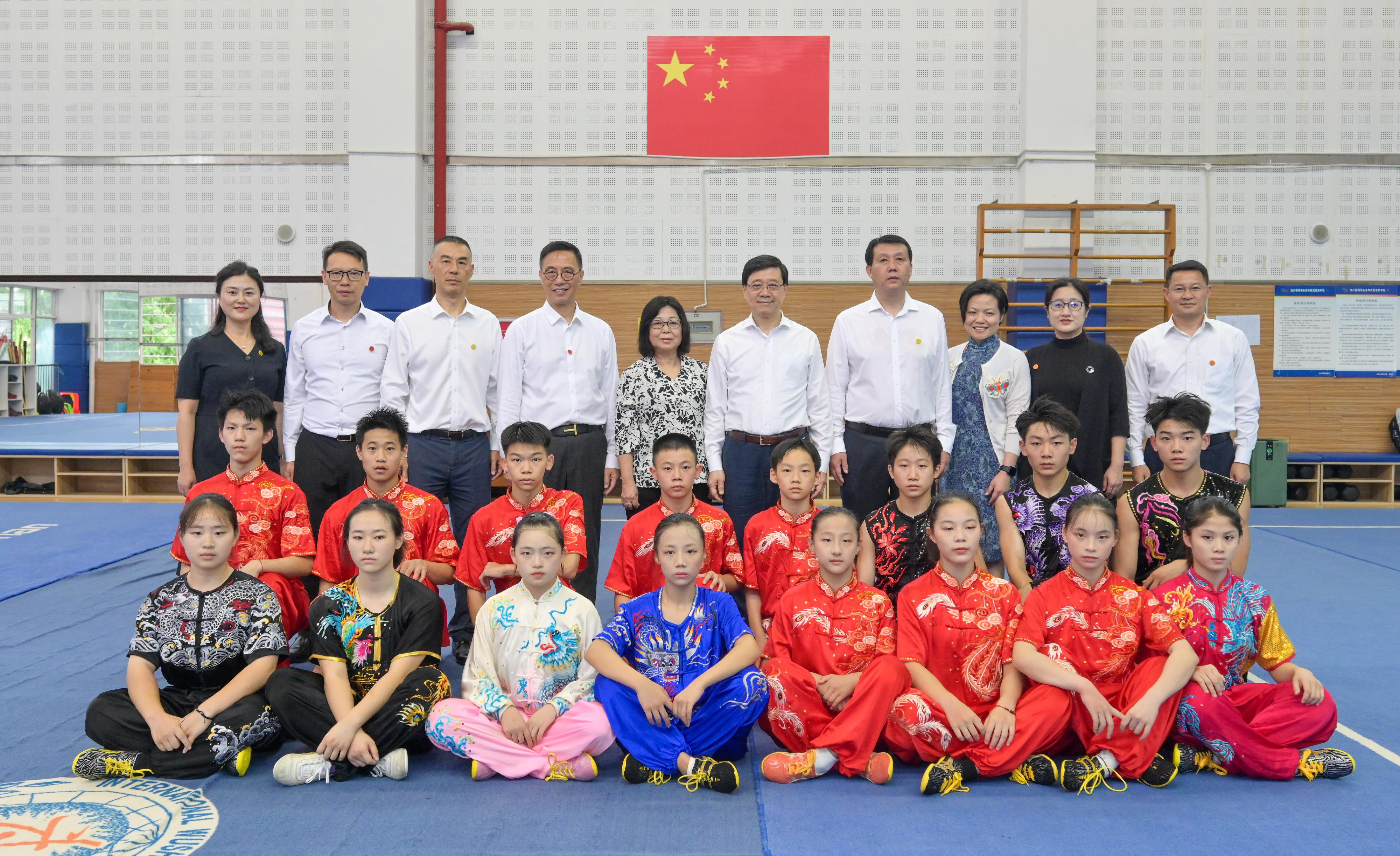 The Chief Executive, Mr John Lee, and his wife Mrs Janet Lee started their visit to Sichuan today (July 8). Photo shows (back row, from fifth right) Mr Lee and his wife Mrs Lee; the Secretary for Culture, Sports and Tourism, Mr Kevin Yeung, other officials, and wushu students at the Sichuan HKJC Olympic School.