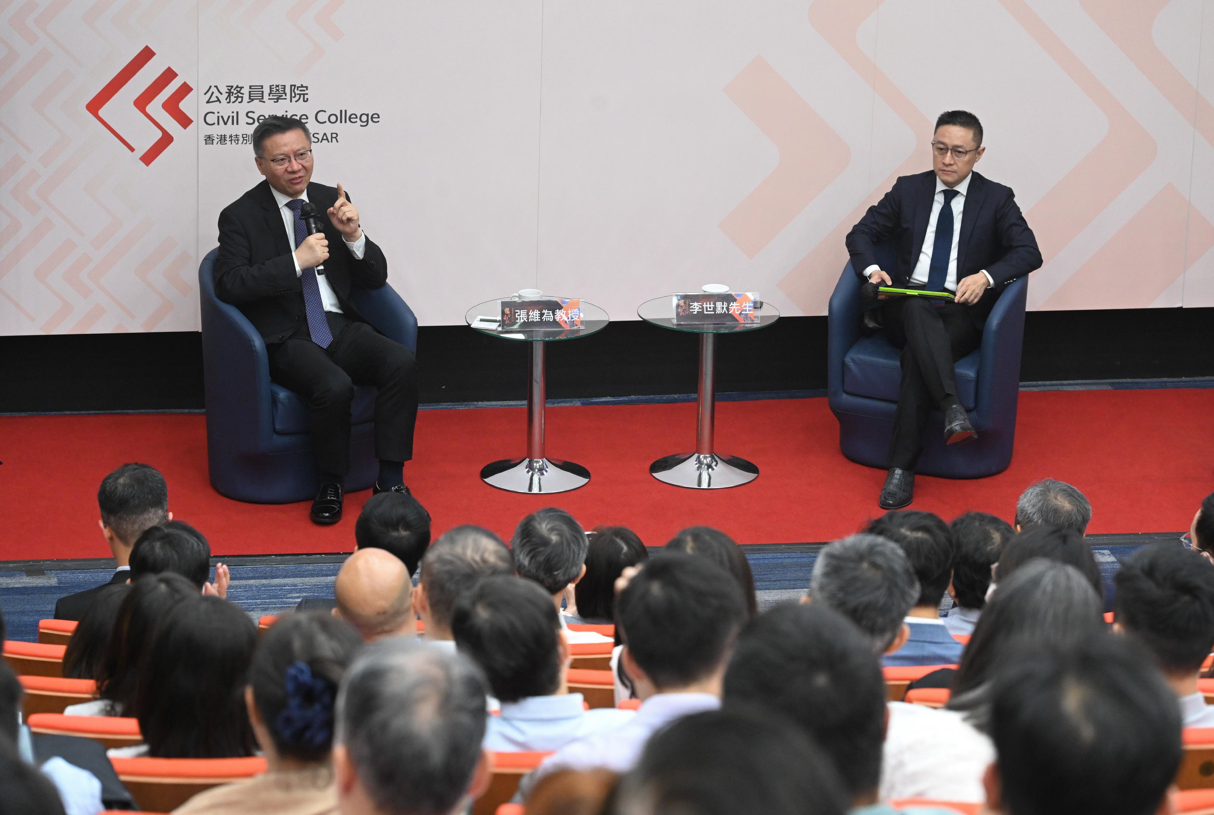 The Civil Service College (CSC) launched the Executive Series on Brokering North and South: China in a Multipolar World. The first seminar on the topic of "A Century of Exploration of the Chinese Path and its Global Significance", was held at the CSC today (July 15). Photo shows the speaker of the seminar and the Dean of the China Institute of Fudan University, Professor Zhang Weiwei (left), answering questions at the Question and Answer Session. The seminar was chaired by the Chairman of the Advisory Committee of the China Institute of Fudan University, Mr Eric Li (right).