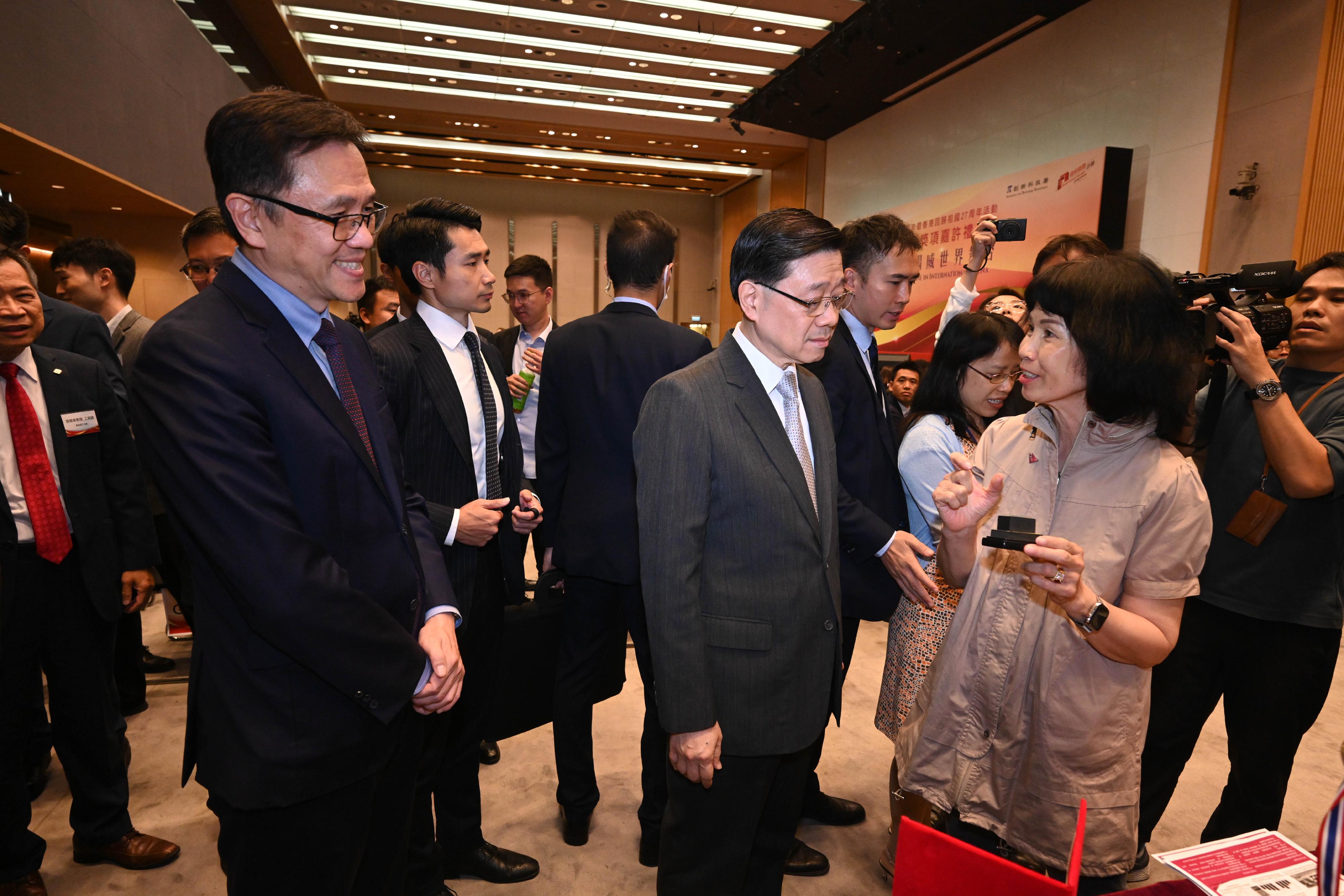 The Chief Executive, Mr John Lee, attended the Reception for I&T Awards 2024 today (July 15). Photo shows Mr Lee (front row, second left) touring the winning projects showcase. Looking on is the Secretary for Innovation, Technology and Industry, Professor Sun Dong  (front row, first left).