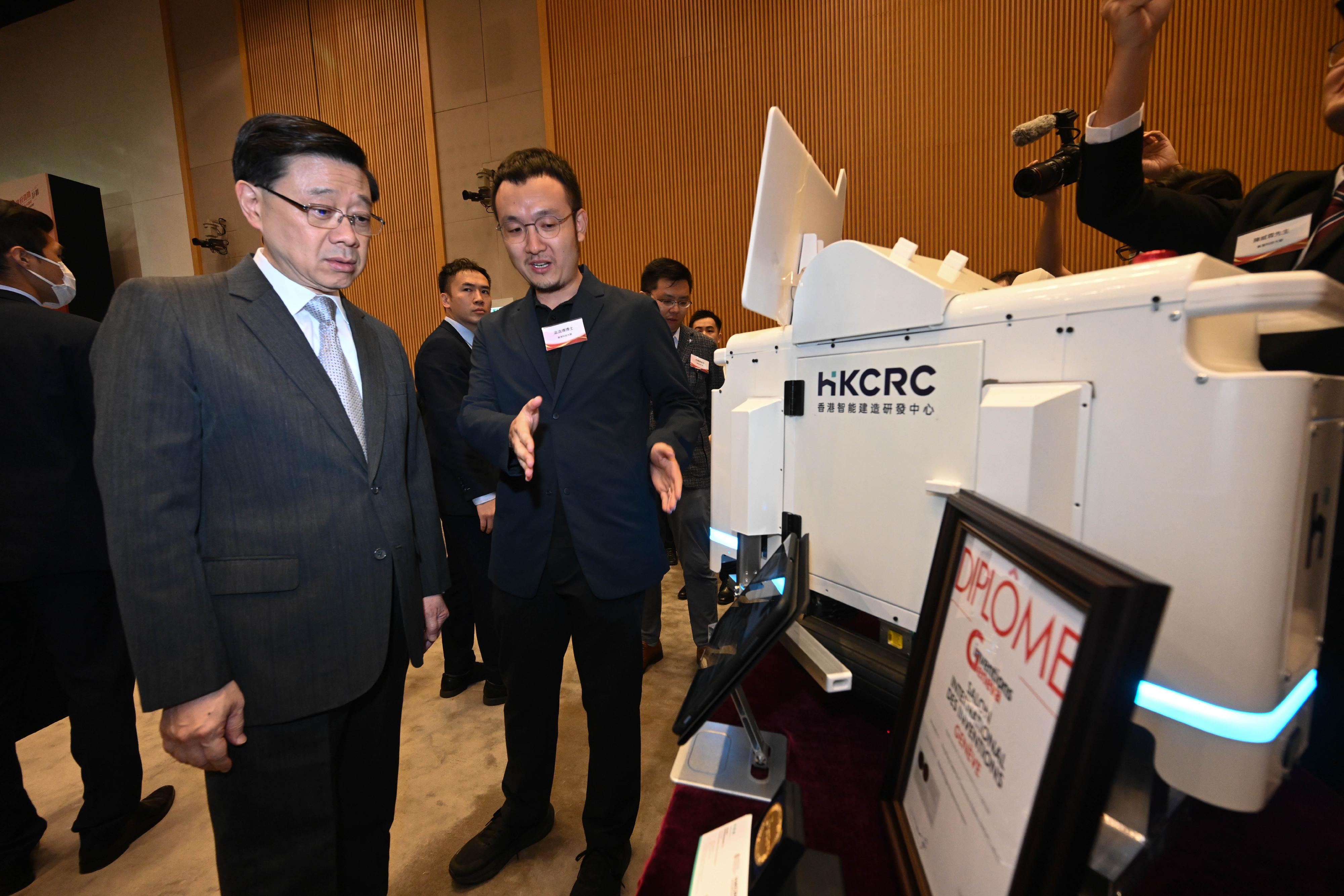 The Chief Executive, Mr John Lee, attended the Reception for I&T Awards 2024 today (July 15). Photo shows Mr Lee (first left) touring the winning projects showcase.