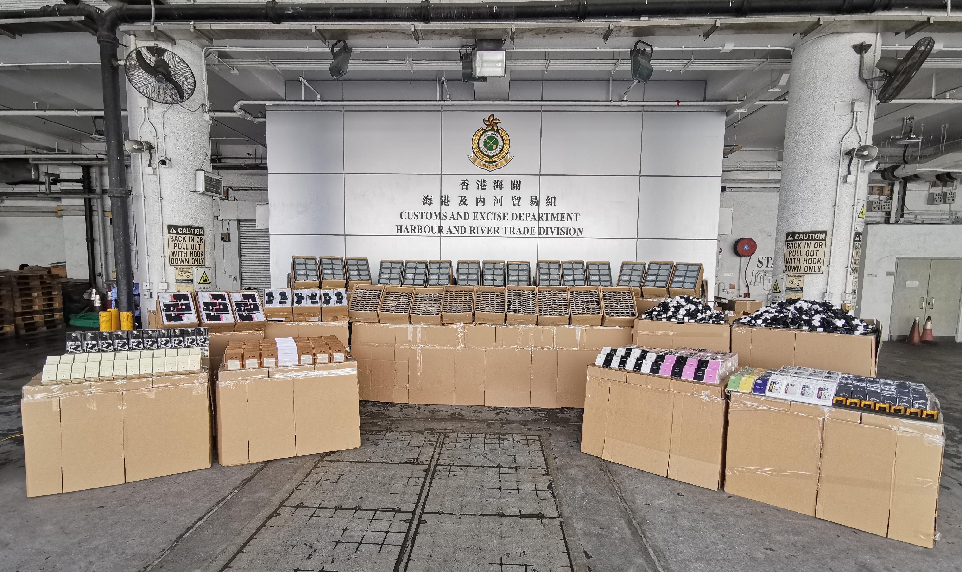 Hong Kong Customs detected two suspected smuggling cases involving ocean-going vessels in July. A large batch of suspected smuggled goods, including perfumes, lighters,  touch screens, oximeters and electronic parts, with a total estimated market value of about $80 million was seized. Photo shows some of the suspected smuggled goods seized.