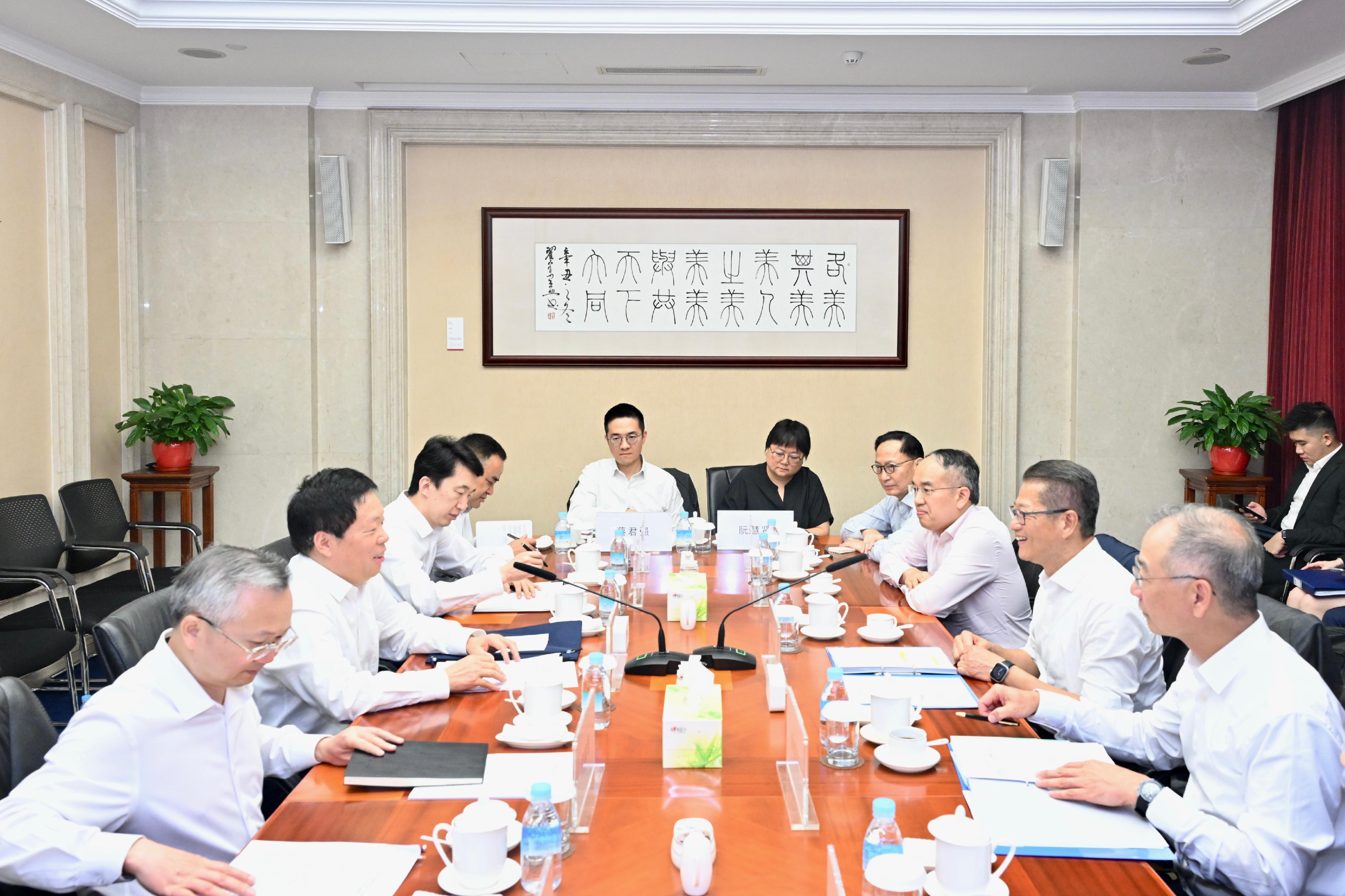 The Financial Secretary, Mr Paul Chan, continued his visit to Beijing today (July 24). Photo shows Mr Chan (second right) meeting with the Deputy Director in charge of routine work of the Office of the Central Commission for Financial and Economic Affairs and Director of the Office of the Central Rural Work Leading Group, Mr Han Wenxiu (second left) and Deputy Director of the Office of the Central Commission for Financial and Economic Affairs Mr Yan Pengcheng (first left). The Secretary for Financial Services and the Treasury, Mr Christopher Hui (third right); the Chief Executive of the Hong Kong Monetary Authority, Mr Eddie Yue (first right); and the Chief Executive Officer of the Insurance Authority, Mr Clement Cheung (fourth right), also attended the meeting.