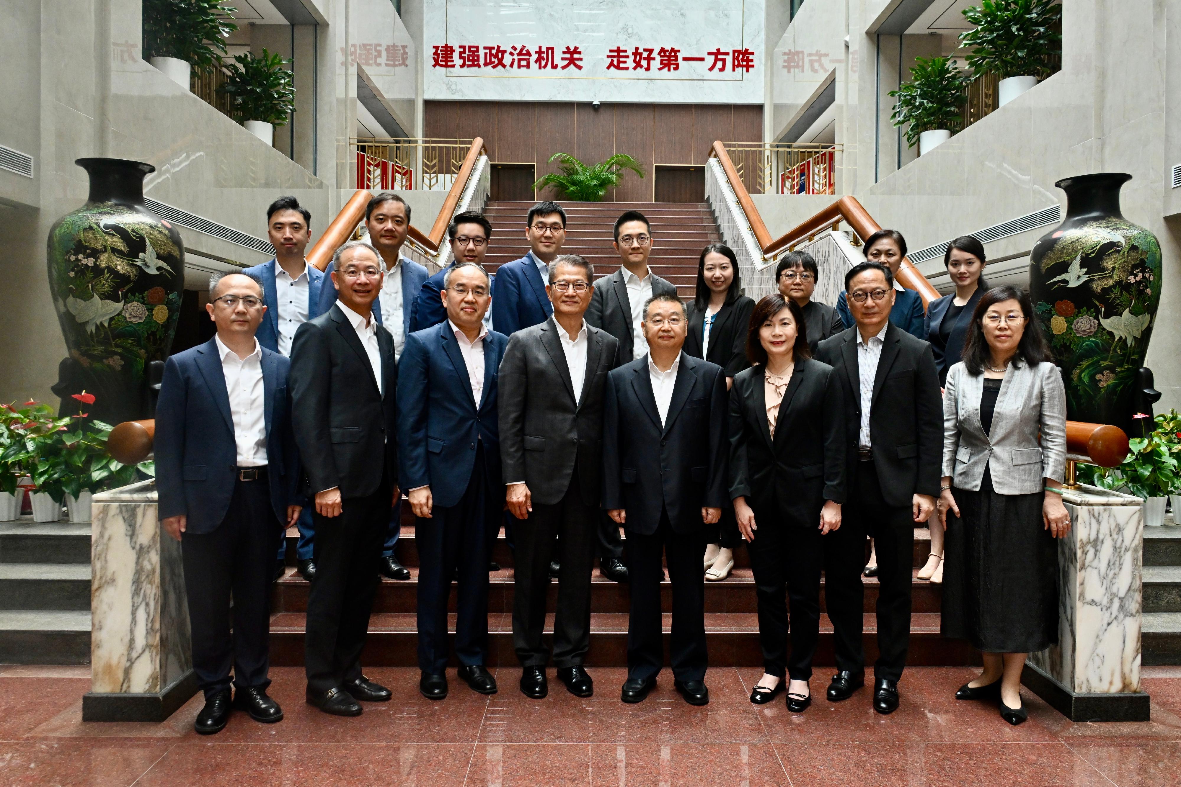 The Financial Secretary, Mr Paul Chan, continued his visit to Beijing today (July 24). Photo shows Mr Chan (front row, fourth left); the Director of the State Taxation Administration, Mr Hu Jinglin (front row, fourth right); the Secretary for Financial Services and the Treasury, Mr Christopher Hui (front row, third left); the Chief Executive of the Hong Kong Monetary Authority, Mr Eddie Yue (front row, second left); the Chief Executive Officer of the Insurance Authority, Mr Clement Cheung (front row, second right); and the Acting Chief Executive Officer of the Securities and Futures Commission, Ms Christina Choi (front row, third right).