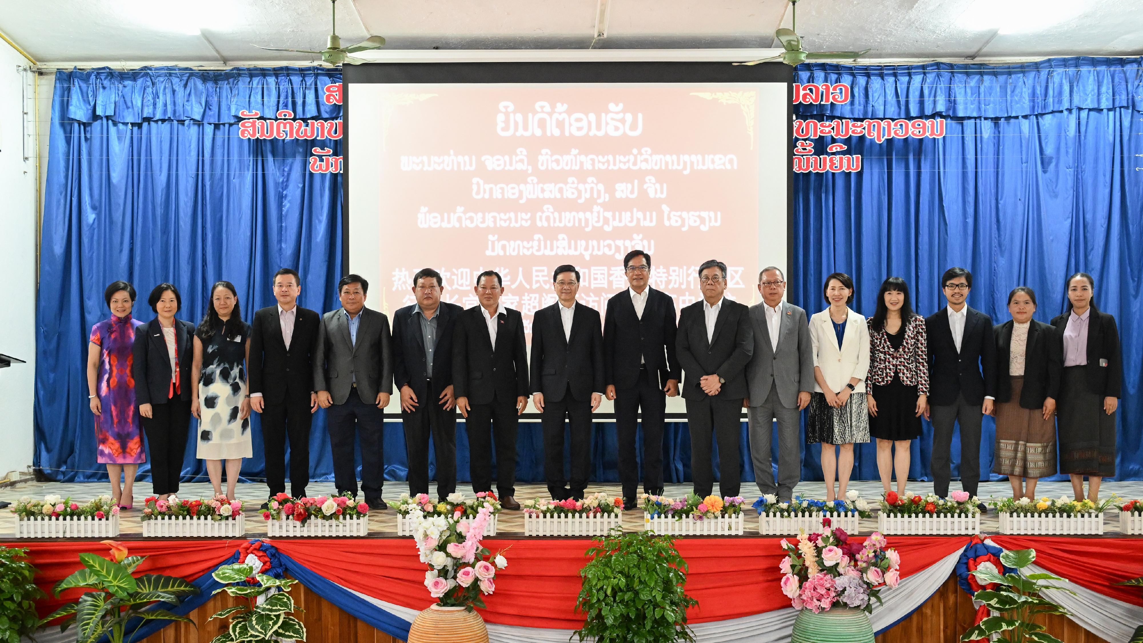 The Chief Executive, Mr John Lee, led a Hong Kong Special Administrative Region Government delegation to Laos and continued his visit programme today (July 29). Photo shows Mr Lee (eighth left); the Deputy Financial Secretary, Mr Michael Wong (eighth right); the Secretary for Commerce and Economic Development, Mr Algernon Yau (seventh right), and the members of the delegation with the school representatives at a secondary school in Laos.