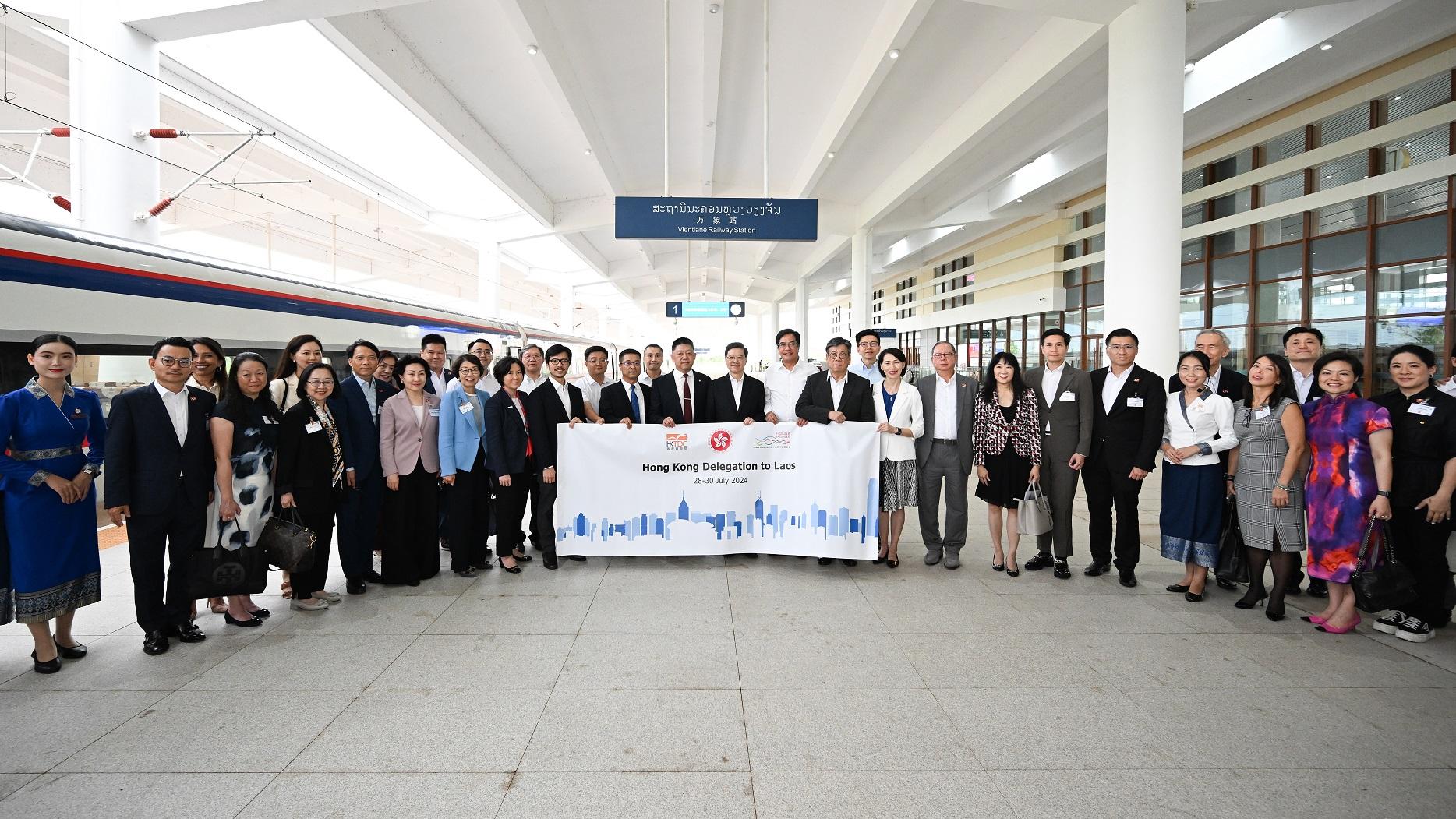 The Chief Executive, Mr John Lee, today (July 29) led a Hong Kong Special Administrative Region delegation to continue their visit in Vientiane, the capital of Laos. Photo shows (front row, from tenth right) the Secretary for Commerce and Economic Development, Mr Algernon Yau; the Deputy Financial Secretary, Mr Michael Wong; Mr Lee, and the delegation members at the Vientiane Station of the China-Laos Railway.