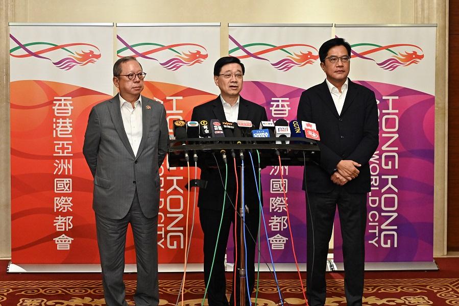 The Chief Executive, Mr John Lee (centre), together with the Chairman of the Hong Kong Trade Development Council, Dr Peter Lam (left) and the Deputy Financial Secretary, Mr Michael Wong (right), meets the media in Laos today (July 29).




