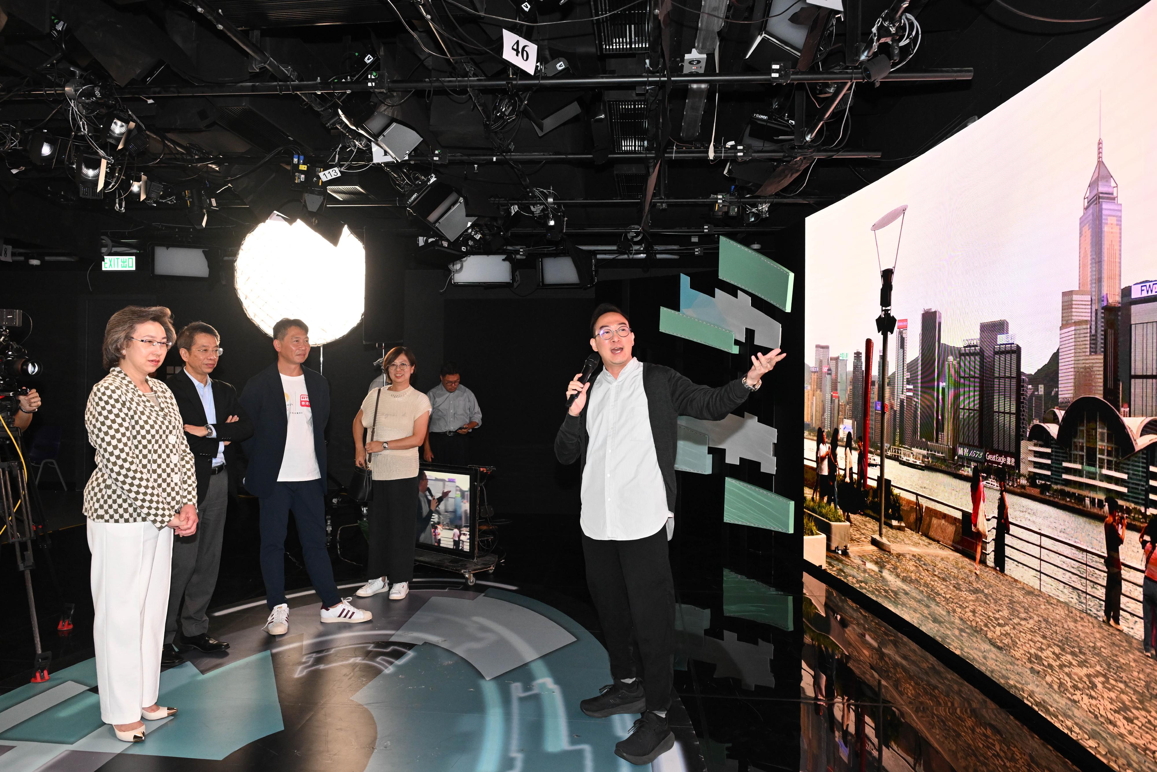 The Secretary for the Civil Service, Mrs Ingrid Yeung, today (July 30) visited the Artificial Intelligence Laboratory and the new studios of Radio Television Hong Kong in Kwun Tong to see the department’s new directions in the use of technology in television production. Photo shows Mrs Yeung (first left) visiting the new studio, which is equipped with a large digital video wall, and watching a demonstration of how the studio's LED screen, which is equipped with virtualisation and augmented reality technology, can be used to integrate virtual environments, real footage and studio scenes into the programme production process, making the images more realistic and achieving versatile production and better visual effects. Looking on are the Permanent Secretary for the Civil Service, Mr Clement Leung (second left), and the Director of Broadcasting, Mr Eddie Cheung (third left).