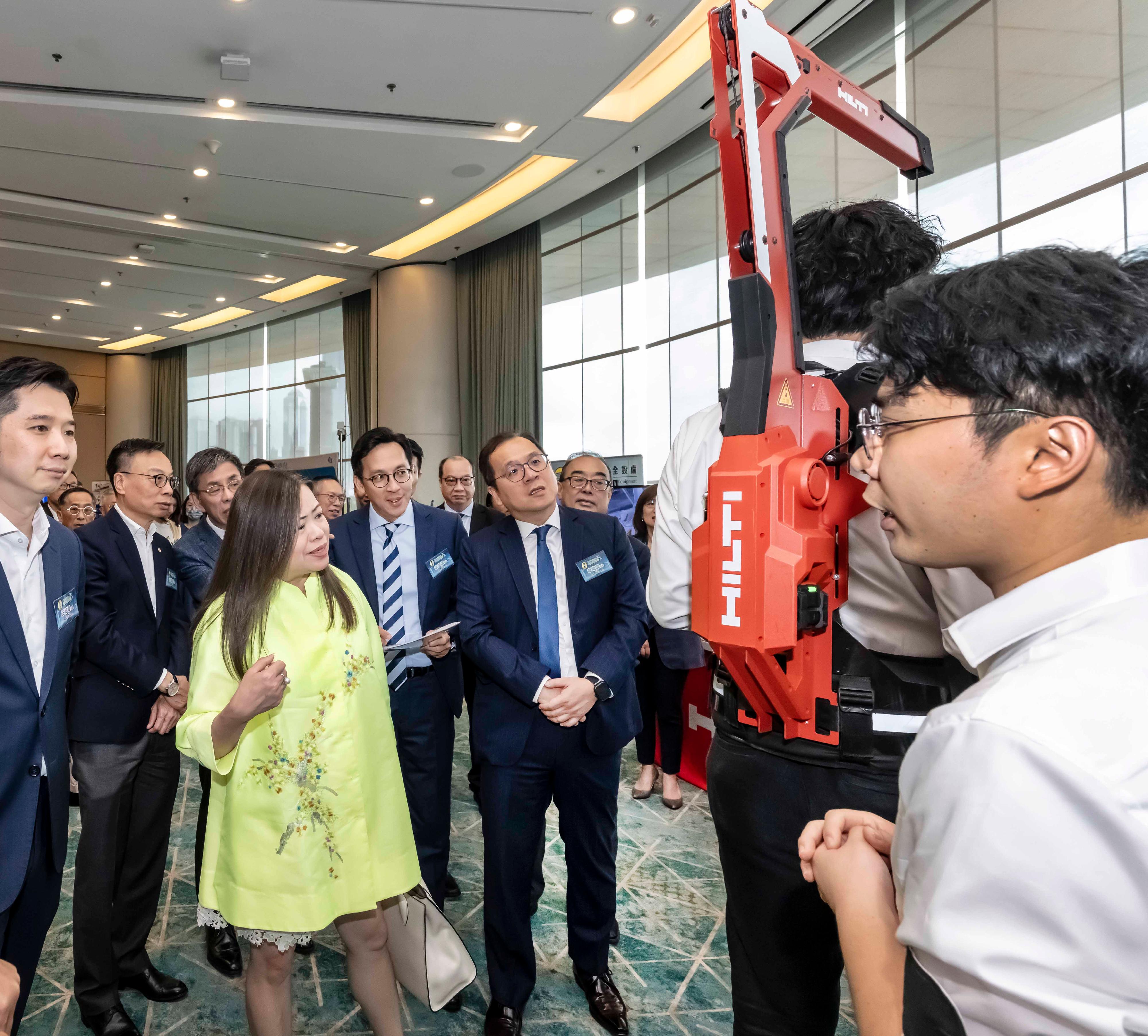 The Permanent Secretary for Housing, Miss Rosanna Law (third left), joined by industry representatives, visited the smart technology equipment exhibition to learn about the latest safety technology products.