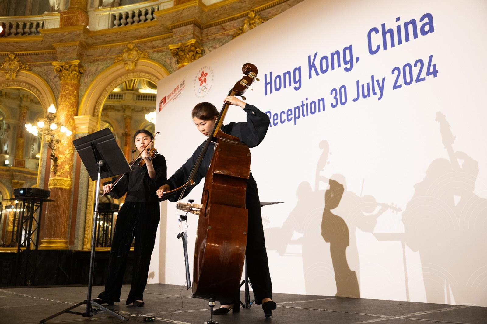 String duo, featuring Hong Kong musicians Grace Chan (right) and Melody Lau (left), perform at the Hong Kong, China Night on July 30 in Paris.