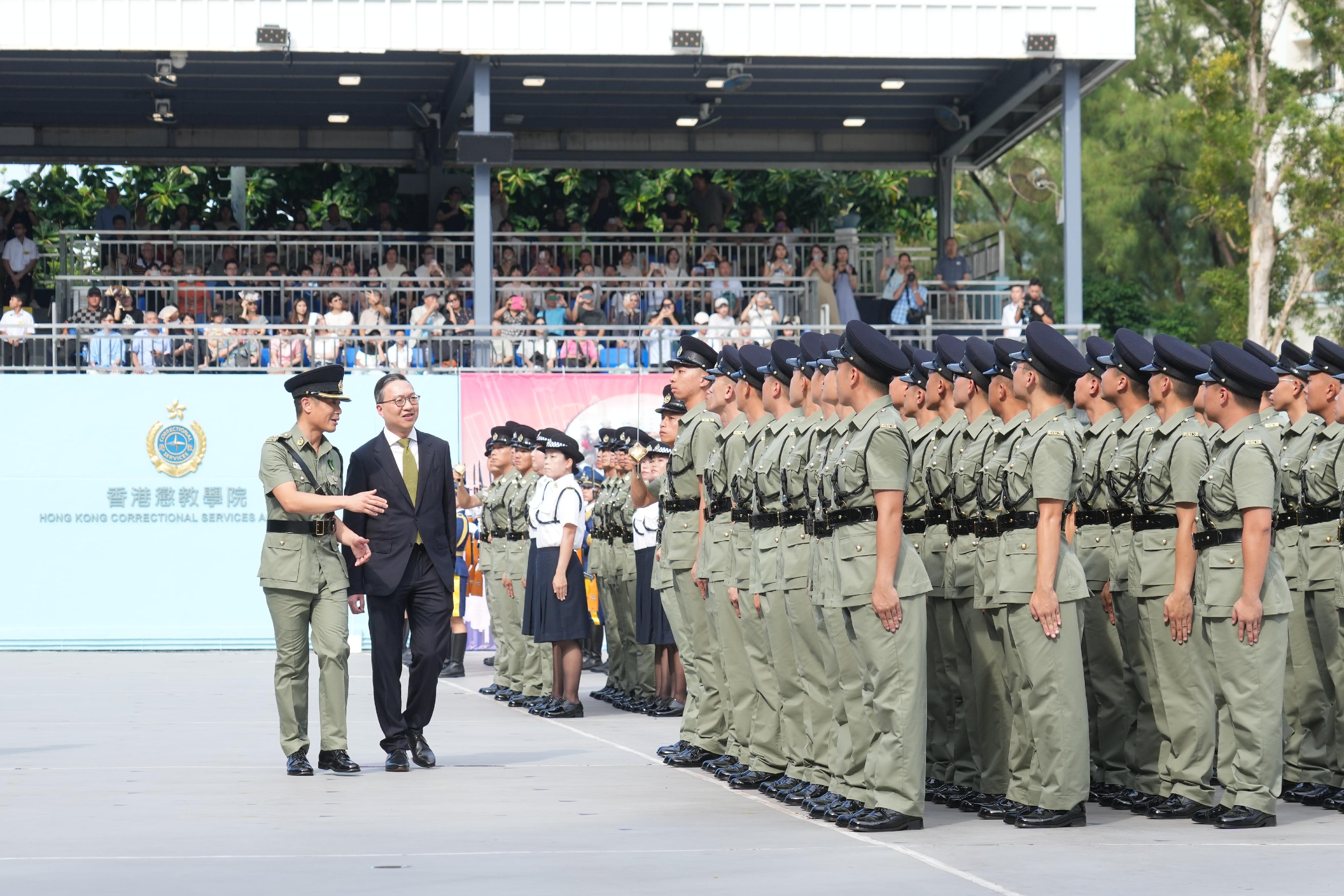 The Correctional Services Department held a passing-out parade at the Hong Kong Correctional Services Academy today (August 2). Photo shows the Secretary for Justice, Mr Paul Lam, SC (second left), inspecting a contingent of graduates.