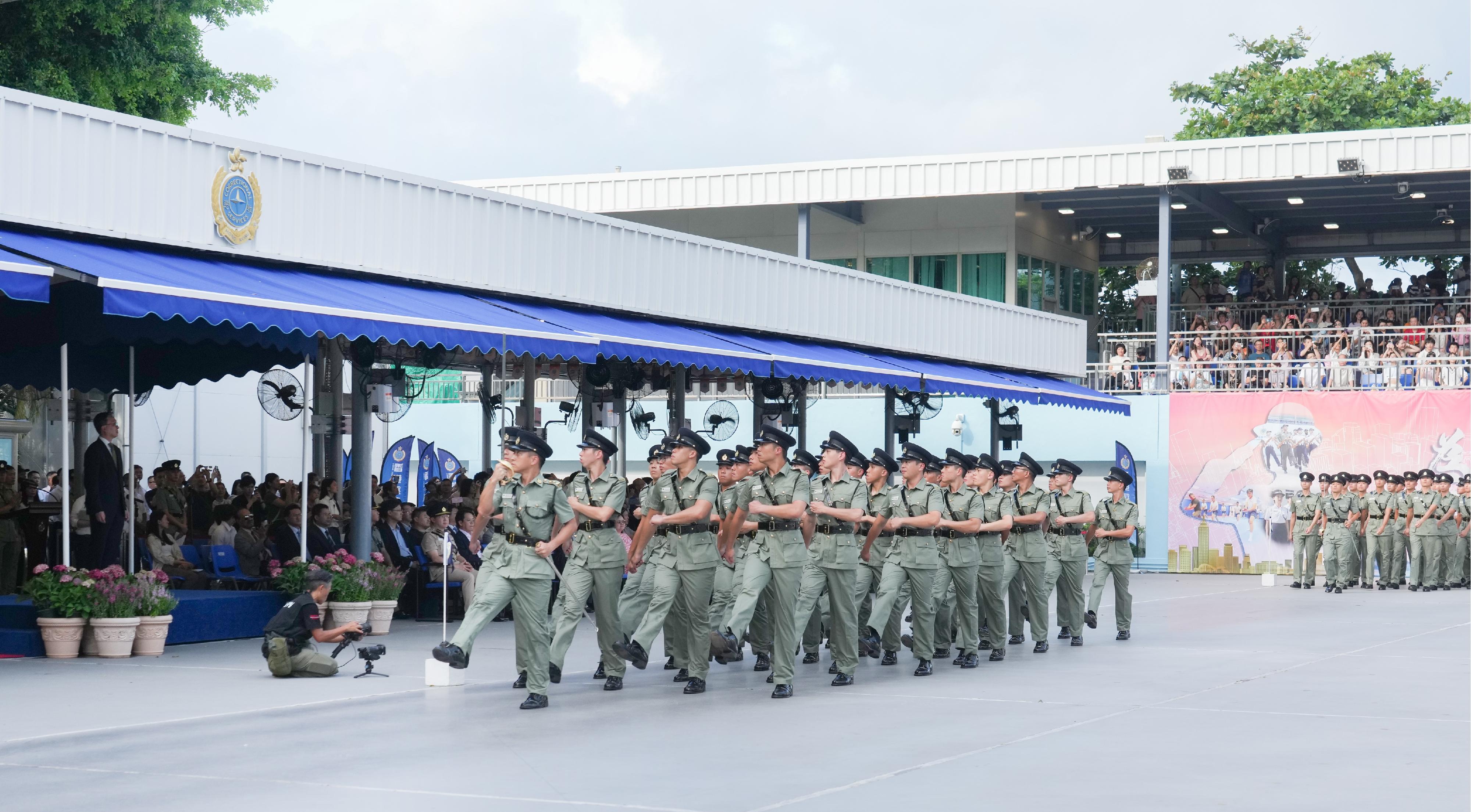 The Correctional Services Department held a passing-out parade at the Hong Kong Correctional Services Academy today (August 2). Photo shows the parade marching past the dais.