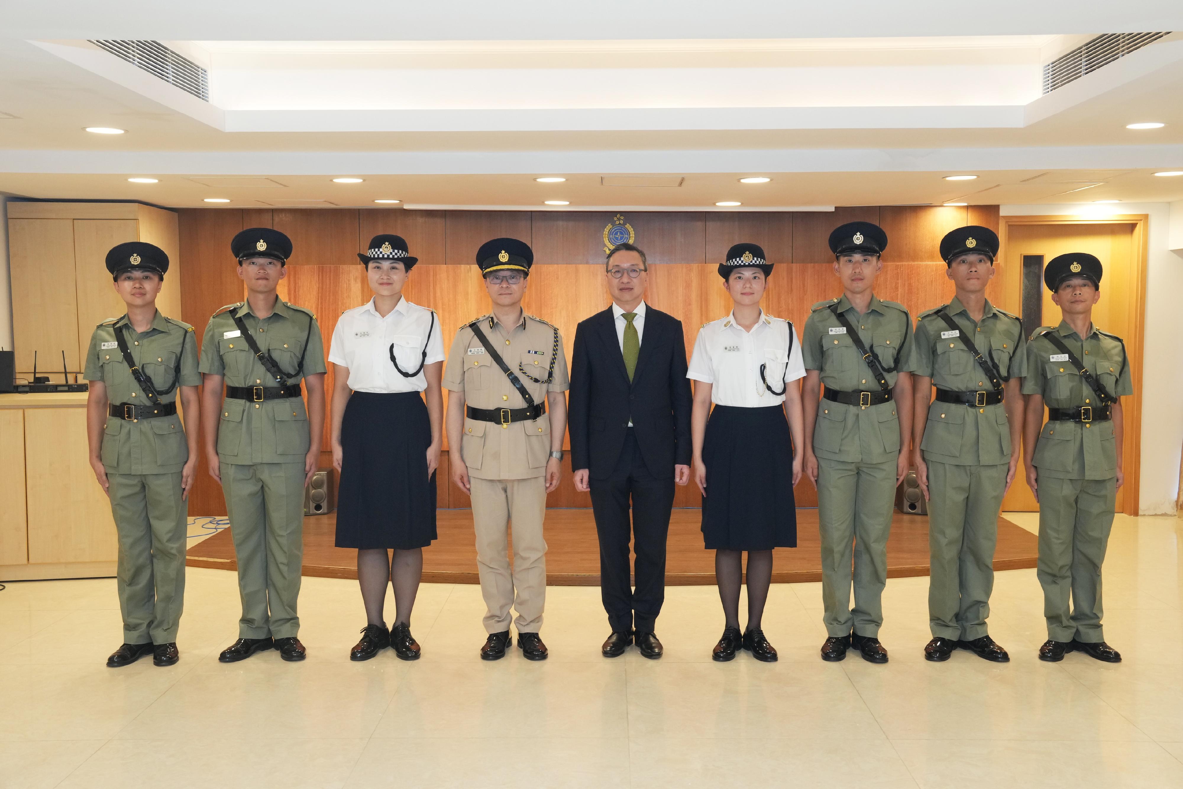 The Secretary for Justice, Mr Paul Lam, SC, reviewed the Correctional Services Department passing-out parade today (August 2). Photo shows Mr Lam (fifth left) and the Commissioner of Correctional Services, Mr Wong Kwok-hing (fourth left), with the awardees of the Best Recruit Awards, namely the Principal's Shield and the Golden Whistle.