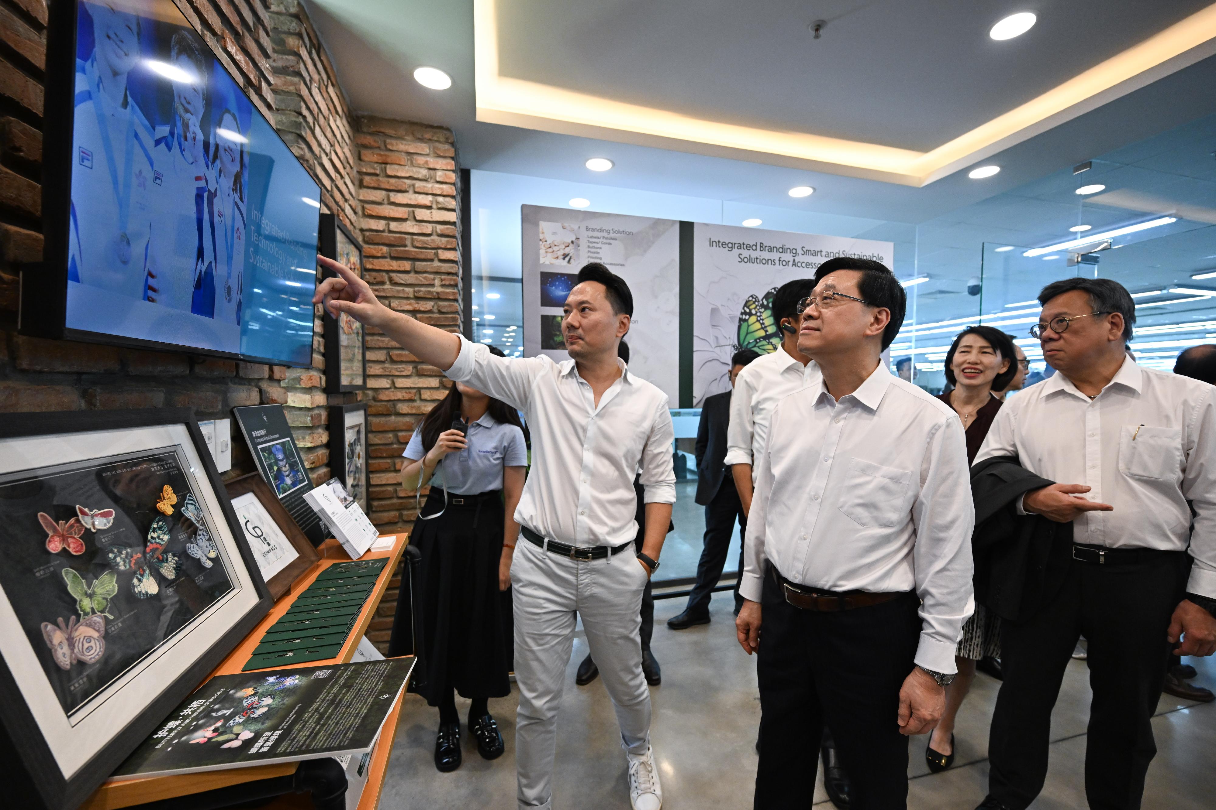 The Chief Executive, Mr John Lee, led a Hong Kong Special Administrative Region delegation to Ho Chi Minh City, Vietnam, and continued his last day visit programme in three member states of the Association of Southeast Asian Nations today (August 2). Photo shows Mr Lee (second left) visiting a garment manufacturer headquartered in Hong Kong.