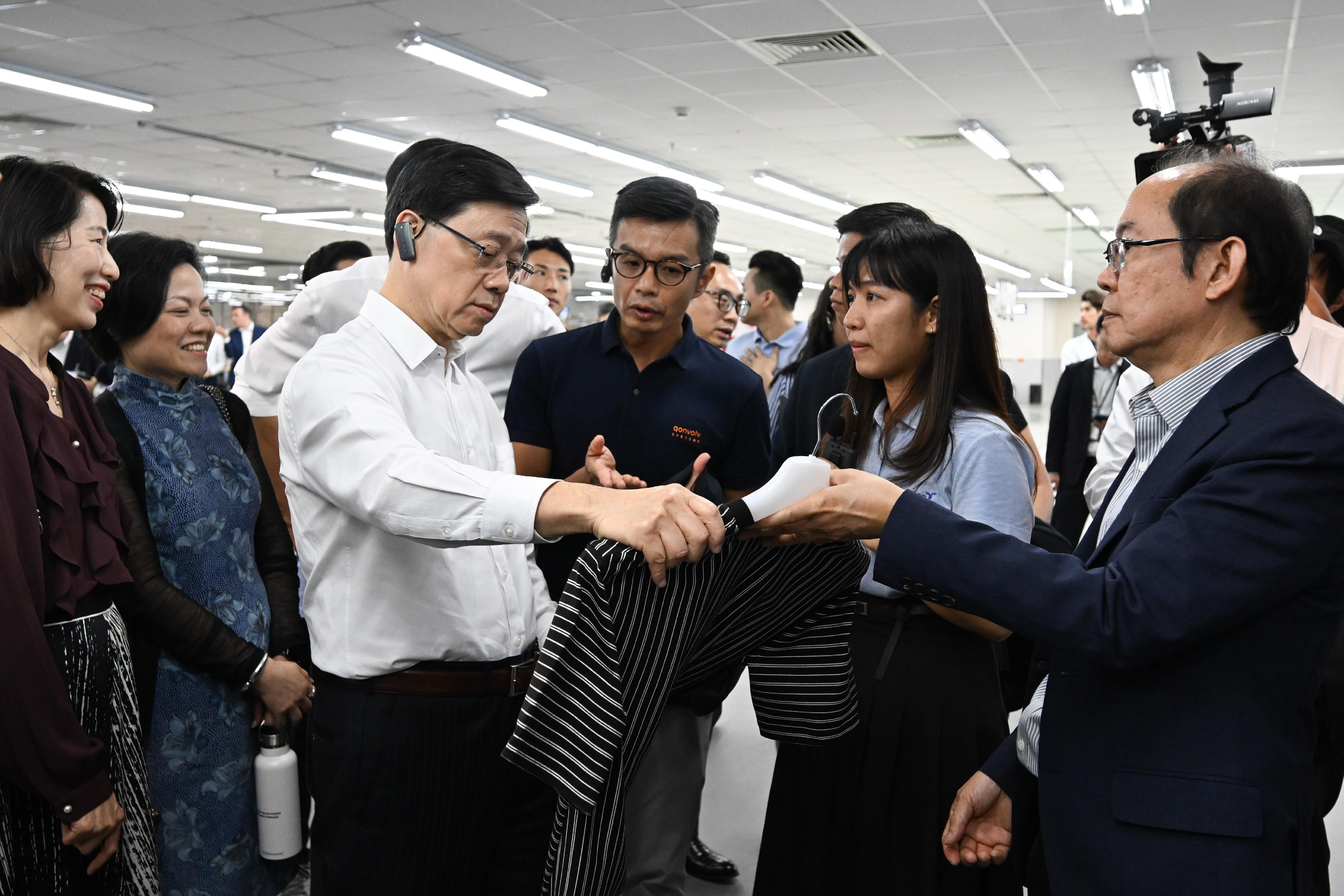 The Chief Executive, Mr John Lee, led a Hong Kong Special Administrative Region delegation to Ho Chi Minh City, Vietnam, and continued his last day visit programme in three member states of the Association of Southeast Asian Nations today (August 2). Photo shows Mr Lee (third left) visiting a garment manufacturer headquartered in Hong Kong.