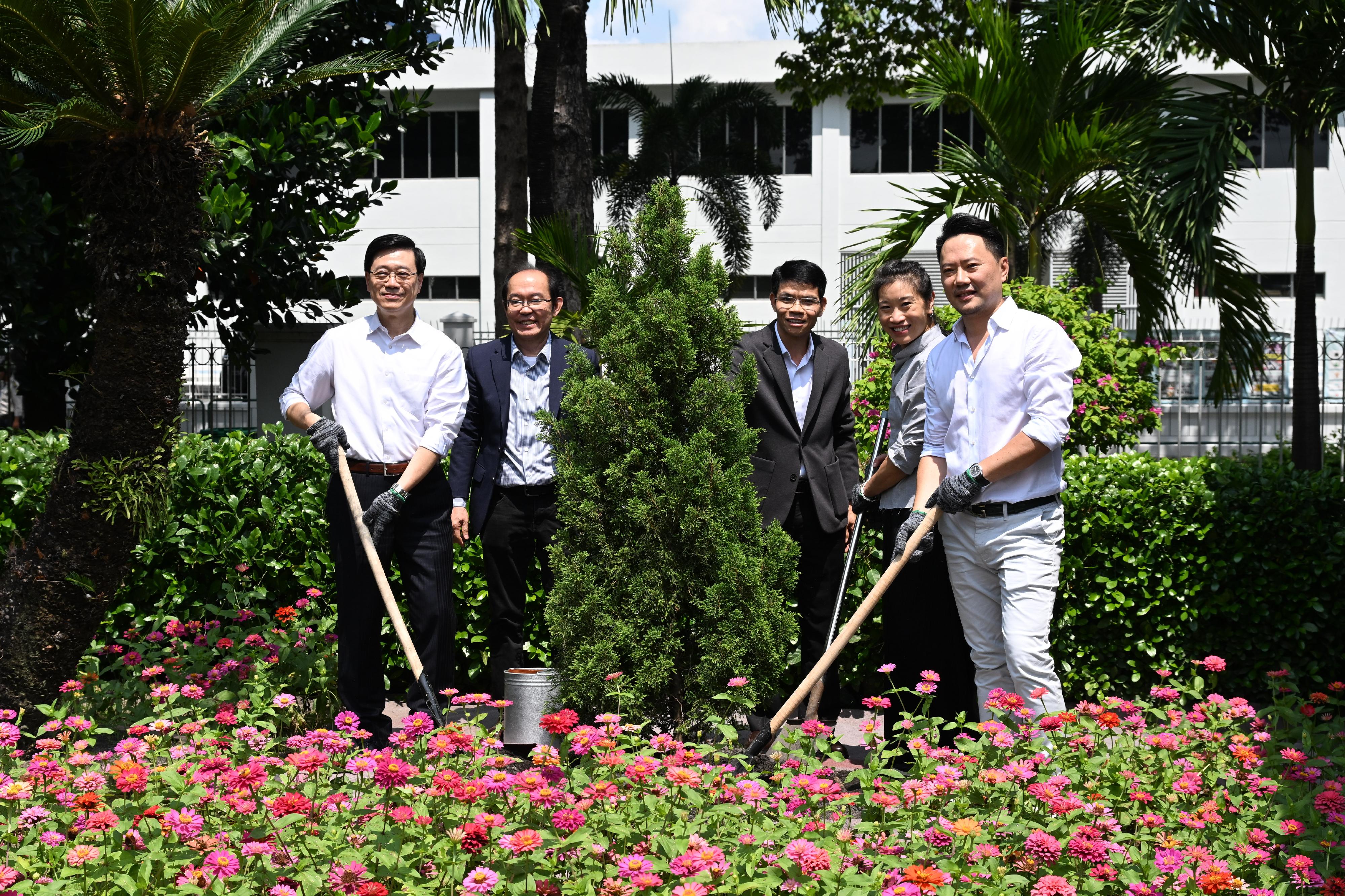 The Chief Executive, Mr John Lee, led a Hong Kong Special Administrative Region delegation to Ho Chi Minh City, Vietnam, and continued his last day visit programme in three member states of the Association of Southeast Asian Nations today (August 2). Photo shows Mr Lee (first left) visiting a garment manufacturer headquartered in Hong Kong and participating in a tree planting ceremony.