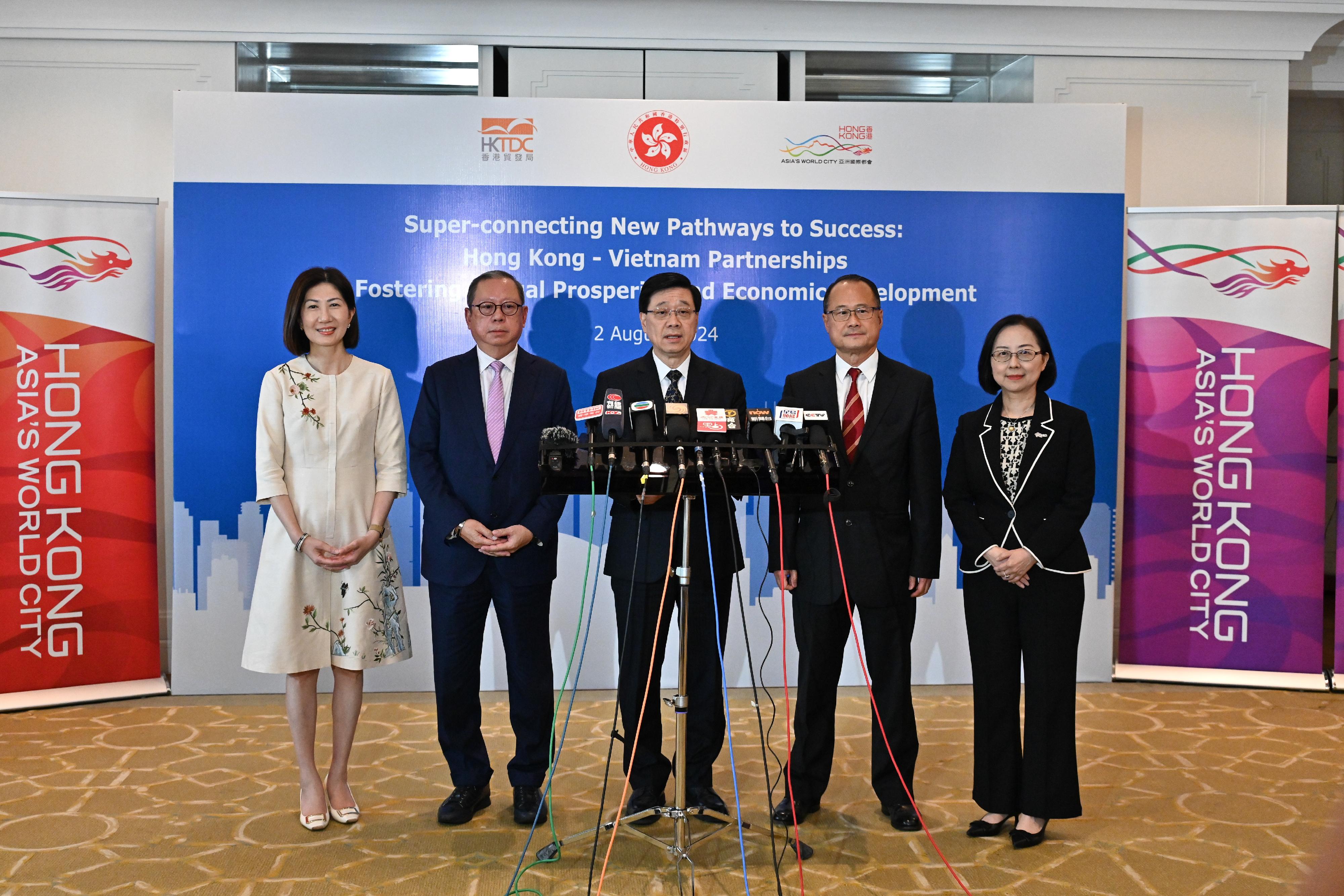 The Chief Executive, Mr John Lee (centre), together with the Chairman of the Hong Kong Trade Development Council, Dr Peter Lam (second left); the Chairman of the Chinese General Chamber of Commerce, Dr Jonathan Choi (second right); the Chief Executive Officer of Hong Kong Exchanges and Clearing Limited, Ms Bonnie Chan (first left), and the Chairman of the Hong Kong General Chamber of Commerce, Ms Agnes Chan (first right), meets the media in Vietnam today (August 2).