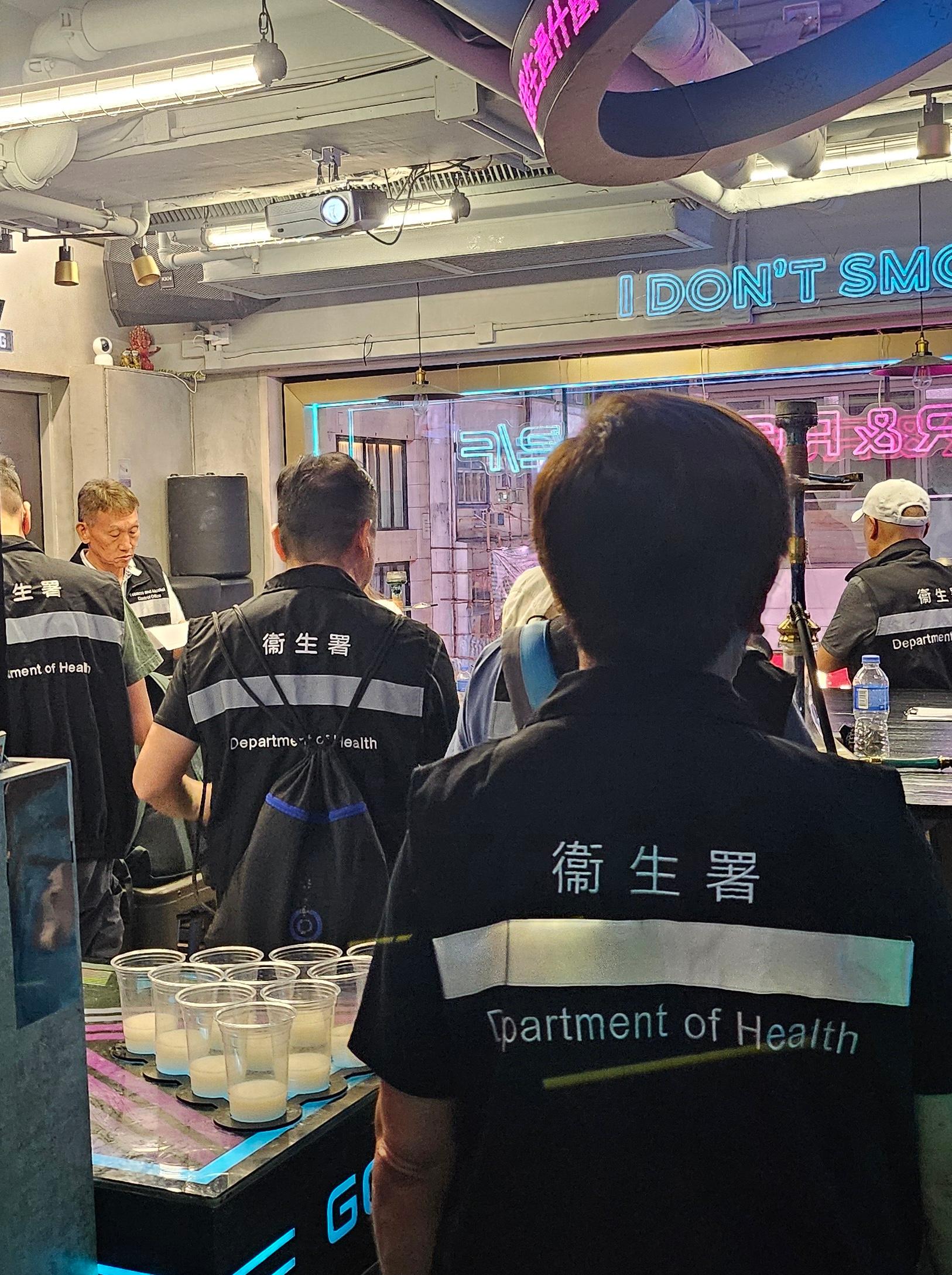 The Tobacco and Alcohol Control Office (TACO) of the Department of Health conducted an enforcement operation against illegal waterpipe smoking activities in no smoking areas in Lan Kwai Fong yesterday night (August 2). Photo shows officers from TACO taking enforcement action inside the bar.
