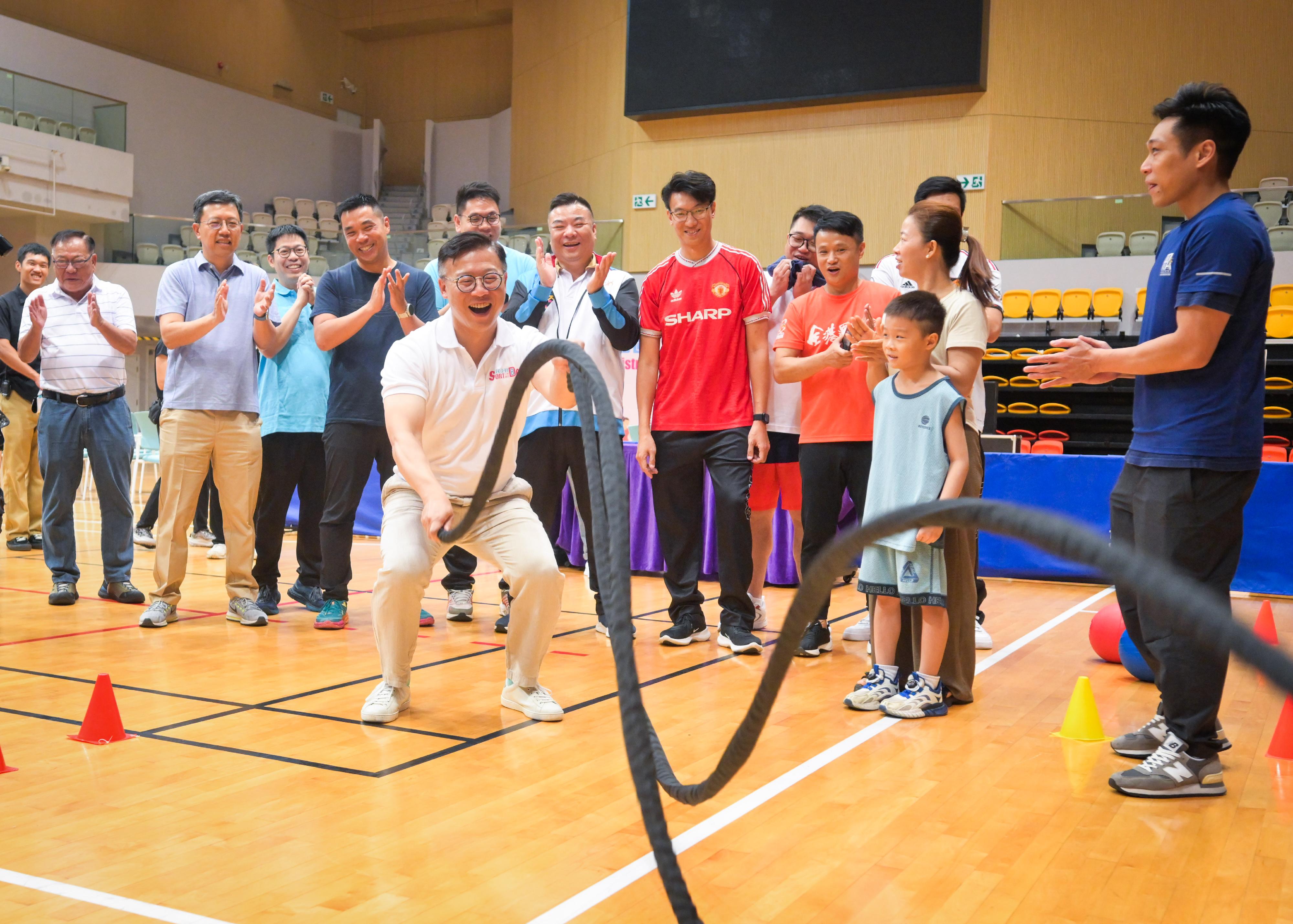 The Deputy Secretary for Justice, Mr Cheung Kwok-kwan, today (August 4) participated in the Sport For All Day 2024 to promote the benefits of exercise for a healthy body and mind lifestyle. Photo shows Mr Cheung (front row, first left) sharing fun with the public in fitness training at the Tsuen Wan Sports Centre.