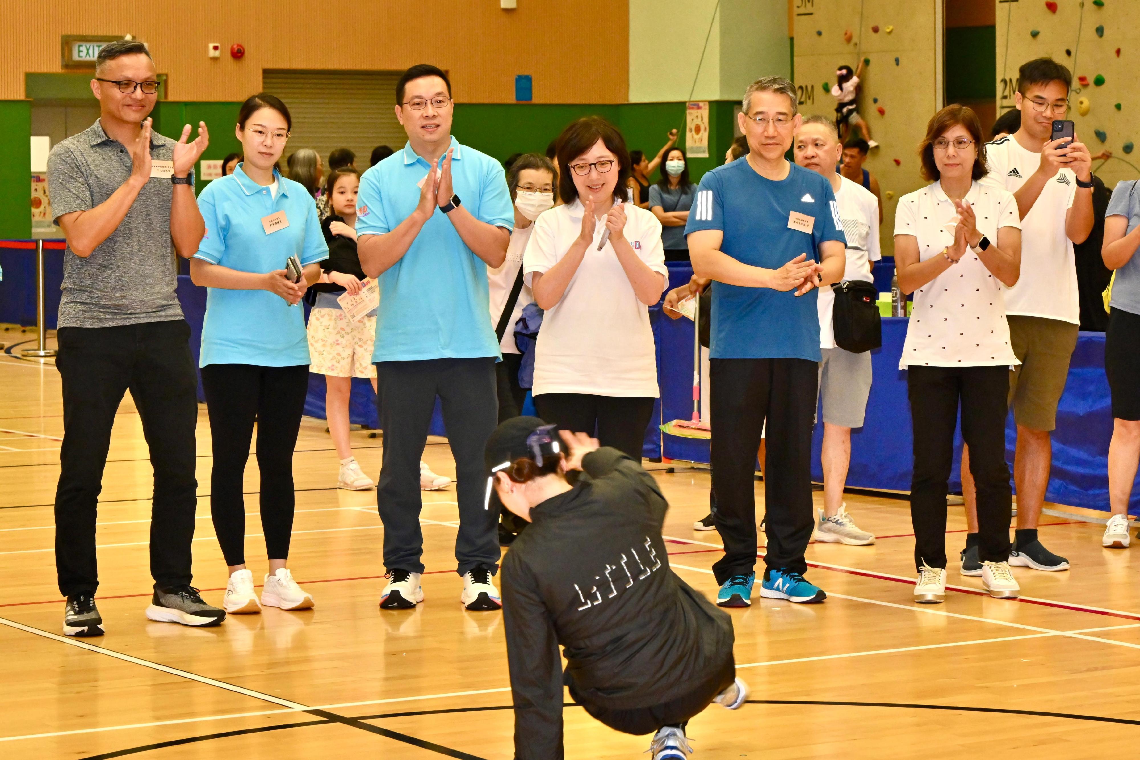 The Secretary for Development, Ms Bernadette Linn, participated in the Sport For All Day 2024 organised by the Leisure and Cultural Services Department at the Island East Sports Centre today (August 4). Photo shows Ms Linn (fourth left, back row) watching breaking demonstration.