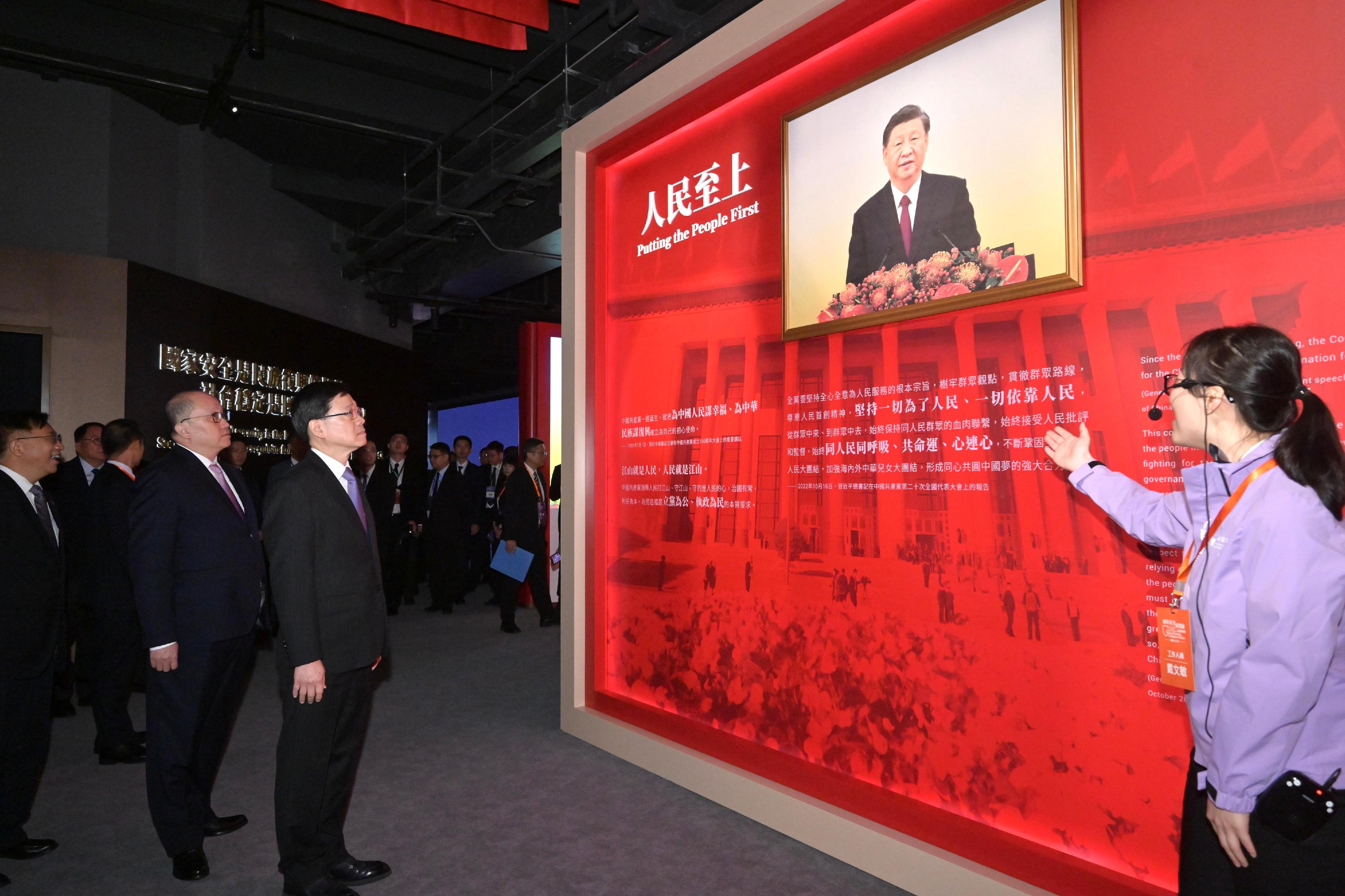 The Chief Executive, Mr John Lee, officiated at the Opening Ceremony of the National Security Exhibition Gallery today (August 6). Photo shows Mr Lee (third left) touring the exhibition. Looking on are the Commissioner of the Ministry of Foreign Affairs in the Hong Kong Special Administrative Region (HKSAR), Mr Cui Jianchun (first left), and the Director of the Liaison Office of the Central People's Government in the HKSAR, Mr Zheng Yanxiong (second left).