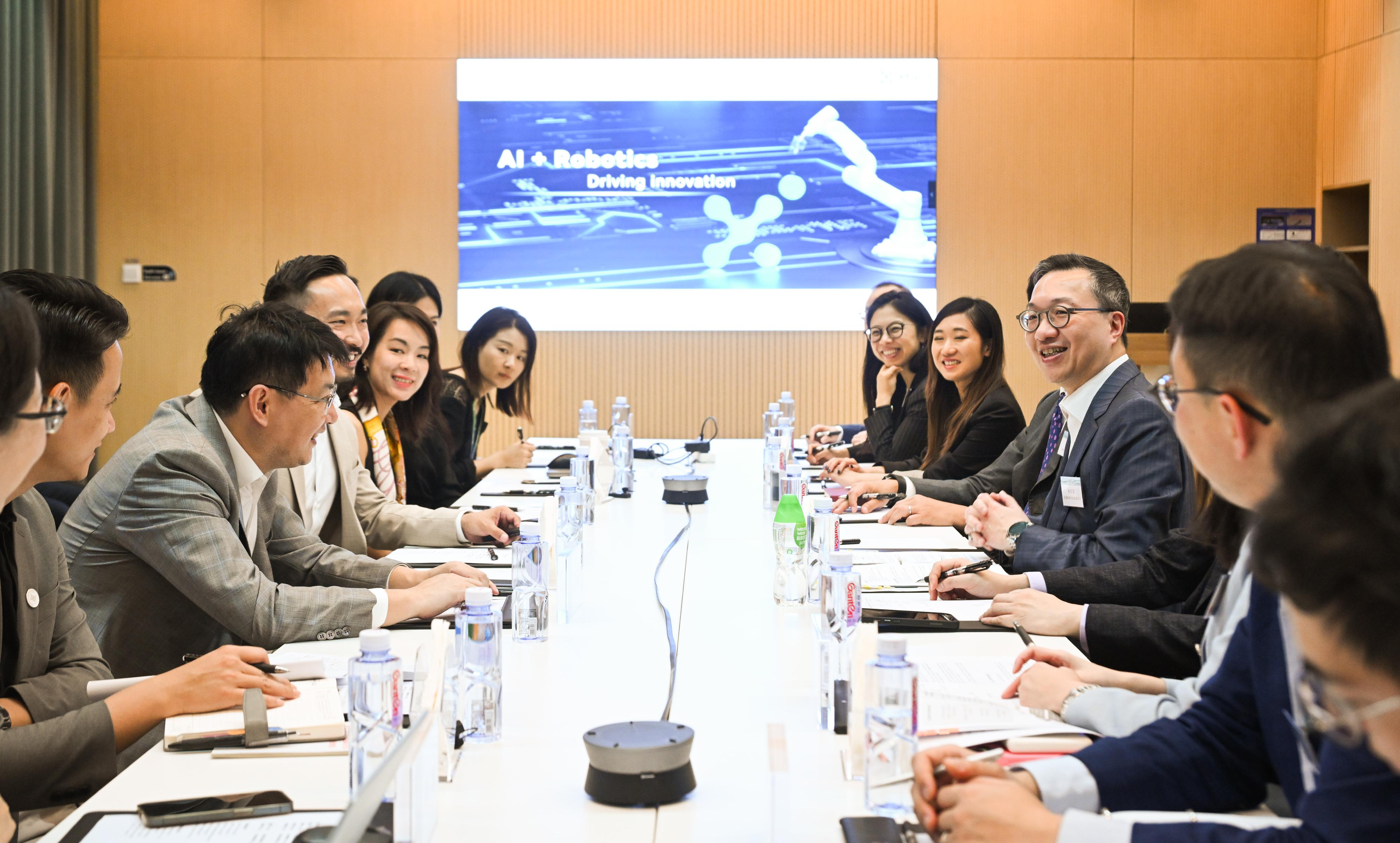 The Secretary for Justice, Mr Paul Lam, SC (fourth right), leading a delegation of about 20 persons comprising representatives from the Hong Kong Bar Association, the Law Society of Hong Kong and related sectors, visited the first specialist technology company listed in Hong Kong under Chapter 18C of the Listing Rules, XtalPi, to learn more about its business development on August 6. 

