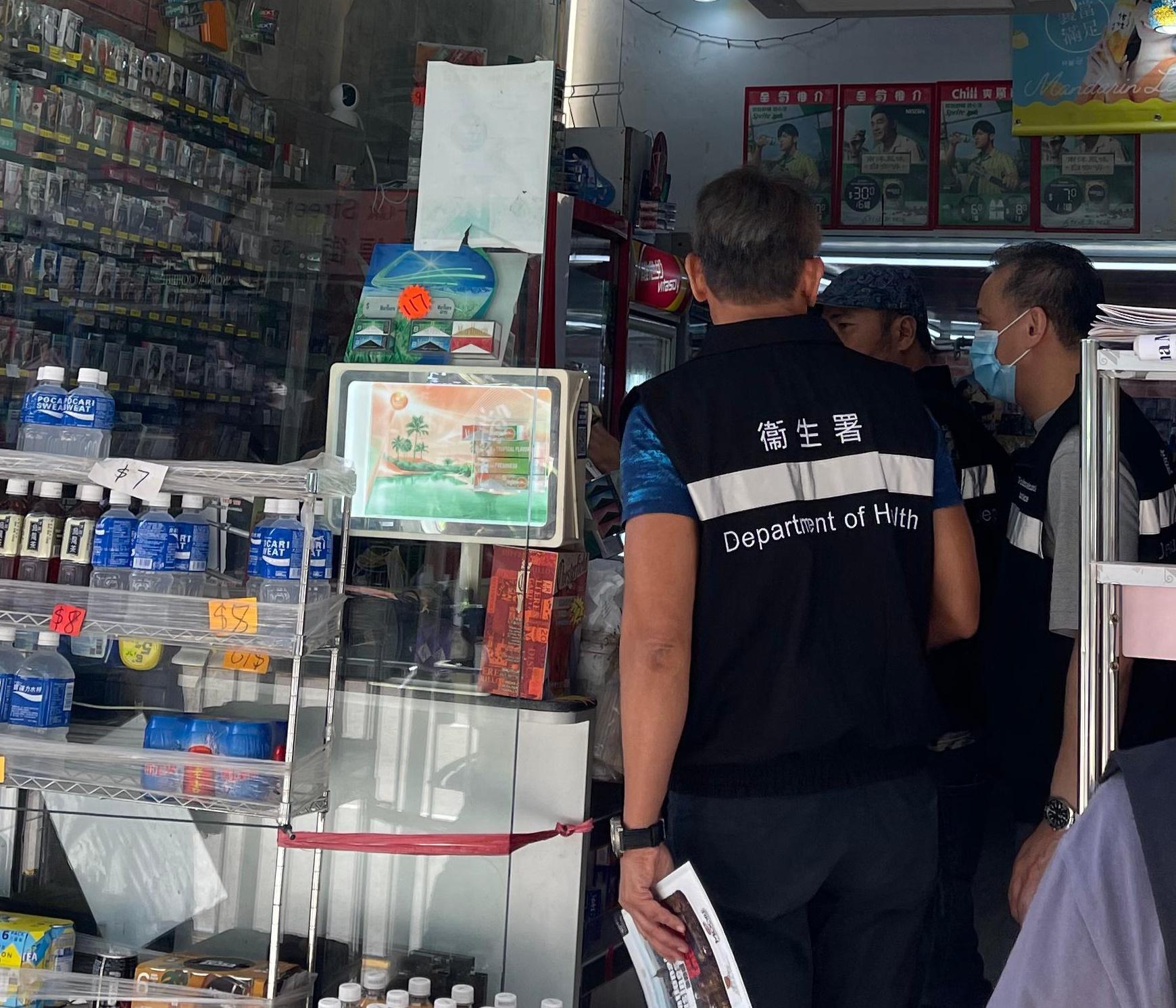 The Tobacco and Alcohol Control Office (TACO) of the Department of Health today (August 8) conducted an enforcement operation in San Po Kong to continue its efforts against illegally displaying smoking product advertisements. Photo shows officers from TACO taking enforcement action at a store.