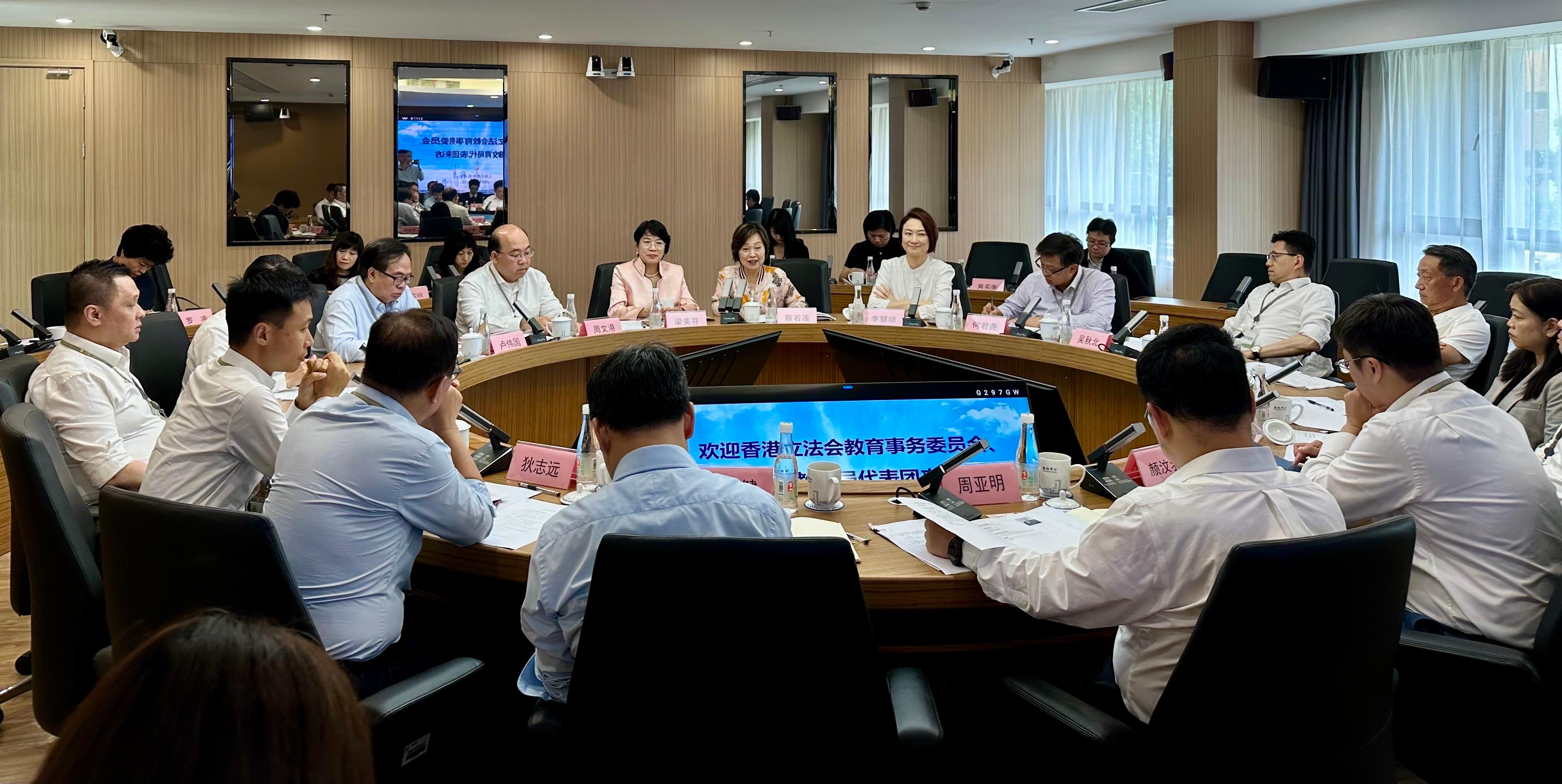 The Secretary for Education, Dr Choi Yuk-lin, together with the Legislative Council Panel on Education delegation, continued their visit to Shanghai today (August 13). Photo shows Dr Choi (back row, centre) and the delegation meeting representatives of the Shanghai Municipal Education Commission.