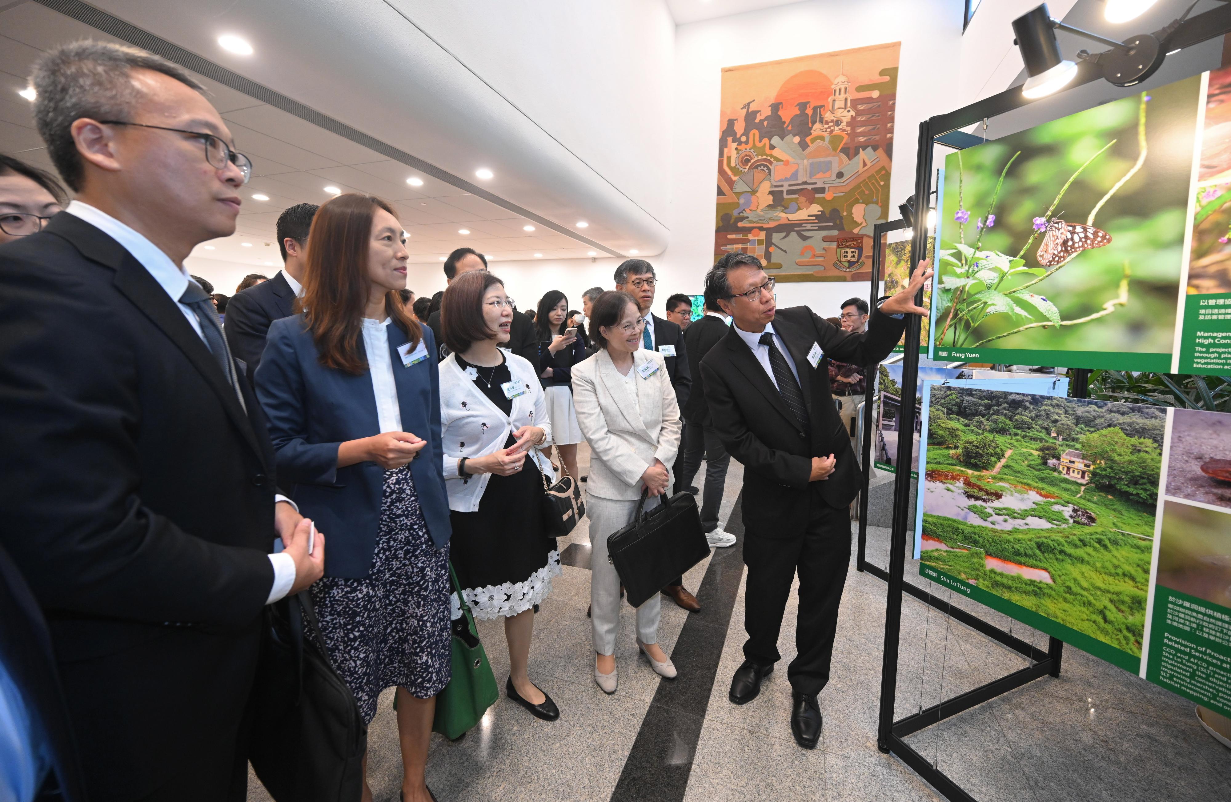 The Government of the Hong Kong Special Administrative Region held the National Ecology Day 2024 Launching Ceremony cum Symposium today (August 15) with a view to raising public awareness towards ecological civilisation and environmental protection. Photo shows the Acting Secretary for Environment and Ecology, Miss Diane Wong (second right), the Permanent Secretary for Environment and Ecology (Environment), Miss Janice Tse (third right), and other guests visiting an exhibition about nature and rural conservation at the venue of the launching ceremony.