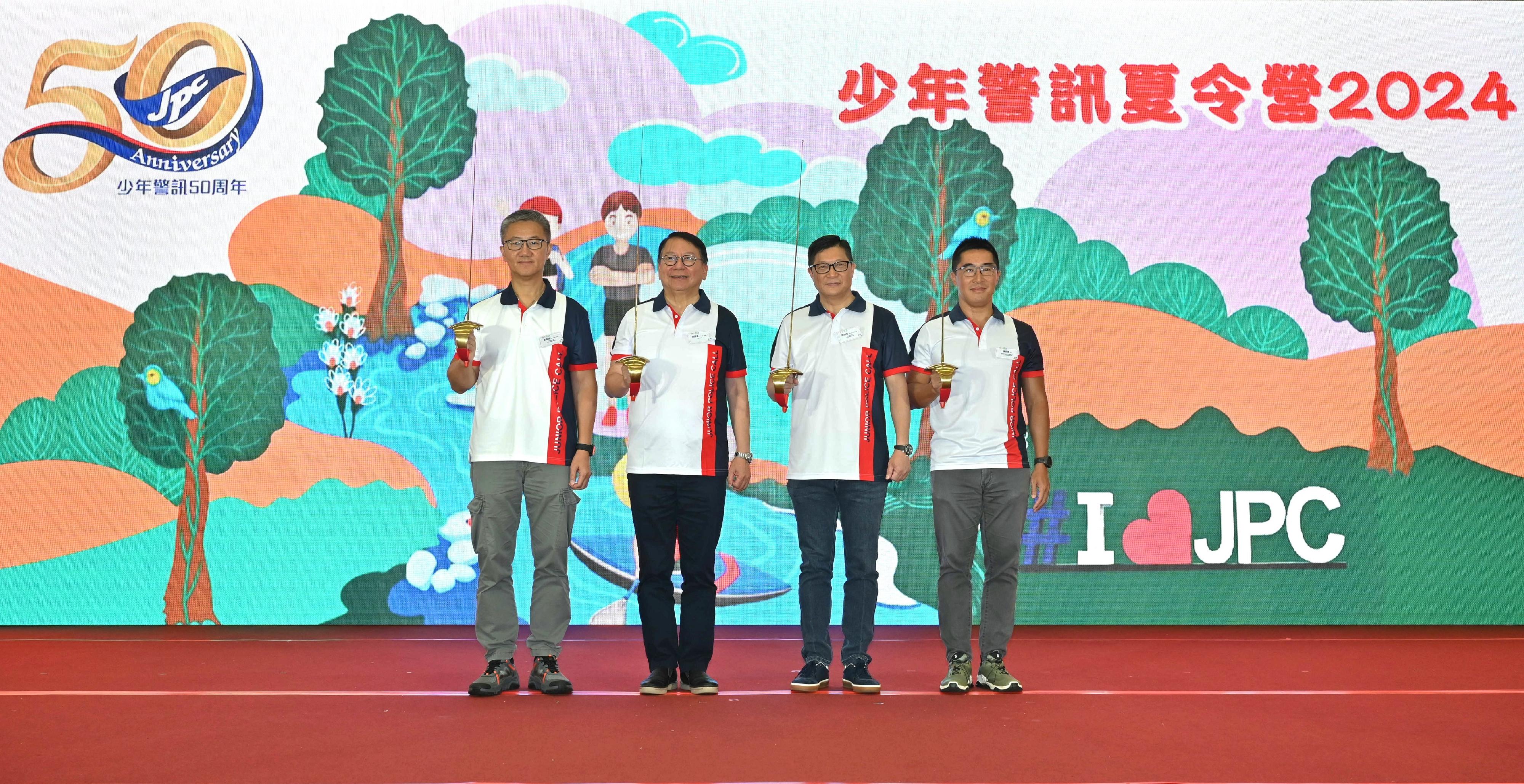 The Chief Secretary for Administration, Mr Chan Kwok-ki (second left); the Secretary for Security cum Junior Police Call (JPC) Honorary Chief President, Mr Tang Ping-keung (second right); the Commissioner of Police cum JPC Honorary Deputy Chief President, Mr Siu Chak-yee (first left); and the Assistant Commissioner of Police (Public Relations) cum Chairperson of JPC Central Advisory Board, Mr Chan Sze-tat (first right), officiated at the Opening Ceremony of Junior Police Call Summer Camp 2024 today (August 17).