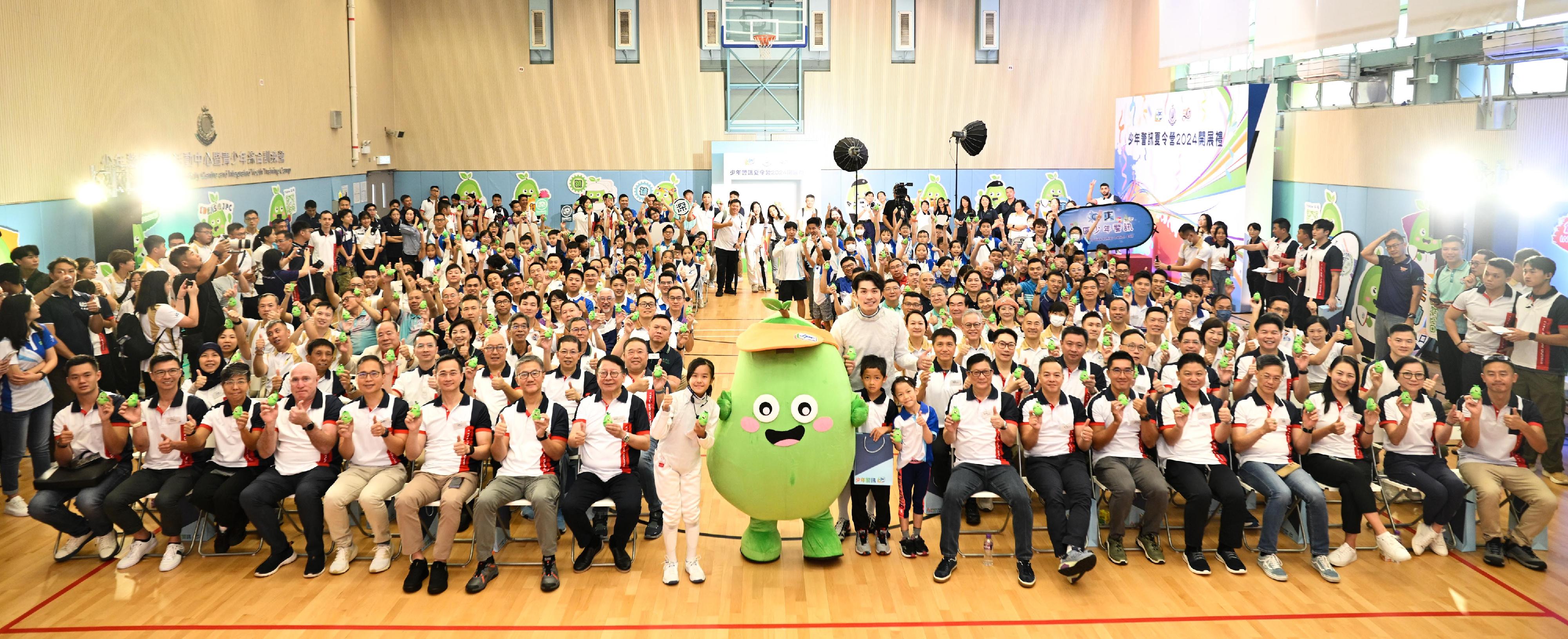 The Opening Ceremony of Junior Police Call (JPC) Summer Camp 2024 was held today (August 17). Picture shows the officiating guests taking a group photo with participants and JPC mascot, Mini Bean.