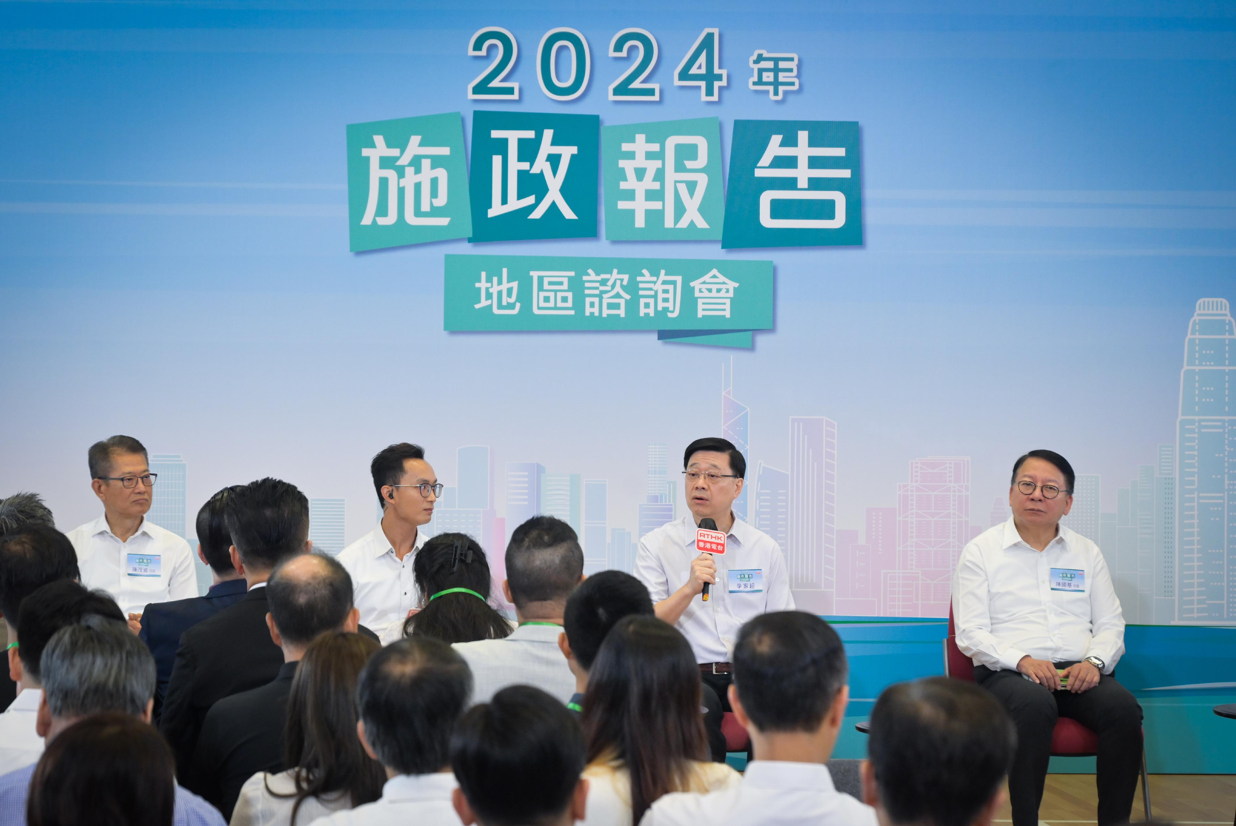 The Chief Executive, Mr John Lee, attended the 2024 Policy Address District Forum with some Principal Officials this morning (August 18) to listen to views and suggestions of local community members on the upcoming Policy Address. Photo shows Mr Lee (second right); the Chief Secretary for Administration, Mr Chan Kwok-ki (first right); and the Financial Secretary, Mr Paul Chan (first left), listening to views of the public at the consultation session.