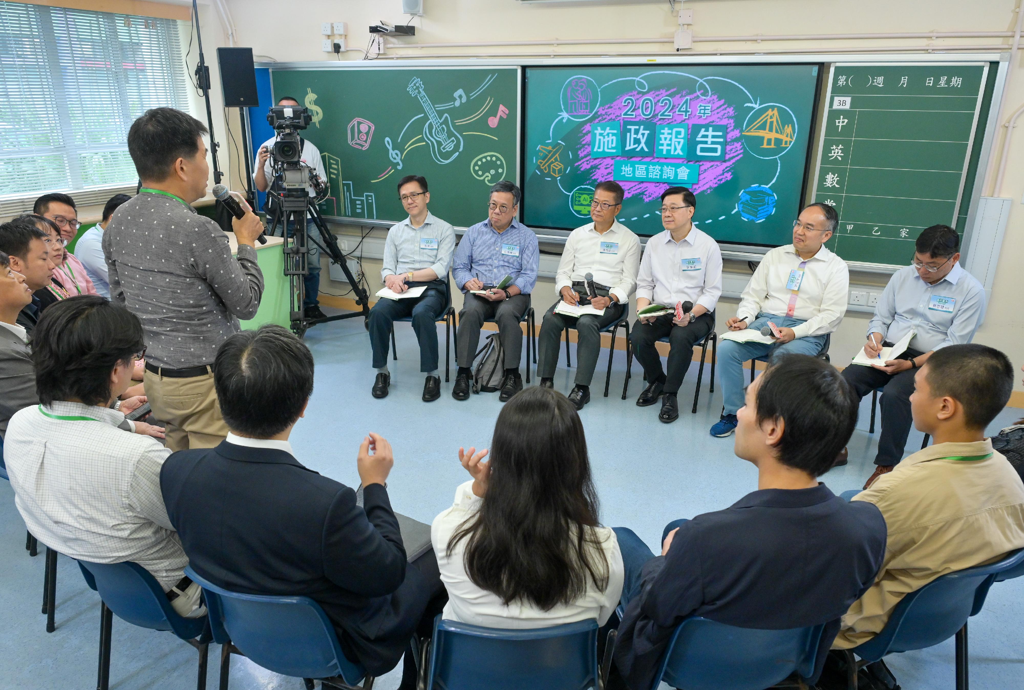 The Chief Executive, Mr John Lee, attended the 2024 Policy Address District Forum with some Principal Officials this morning (August 18) to listen to views and suggestions of local community members on the upcoming Policy Address. Photo shows (from left) the Secretary for Innovation, Technology and Industry, Professor Sun Dong; the Secretary for Commerce and Economic Development, Mr Algernon Yau; the Financial Secretary, Mr Paul Chan; Mr Lee; the Secretary for Financial Services and the Treasury, Mr Christopher Hui; and the Secretary for Transport and Logistics, Mr Lam Sai-hung, listening to views of the public at the consultation session.