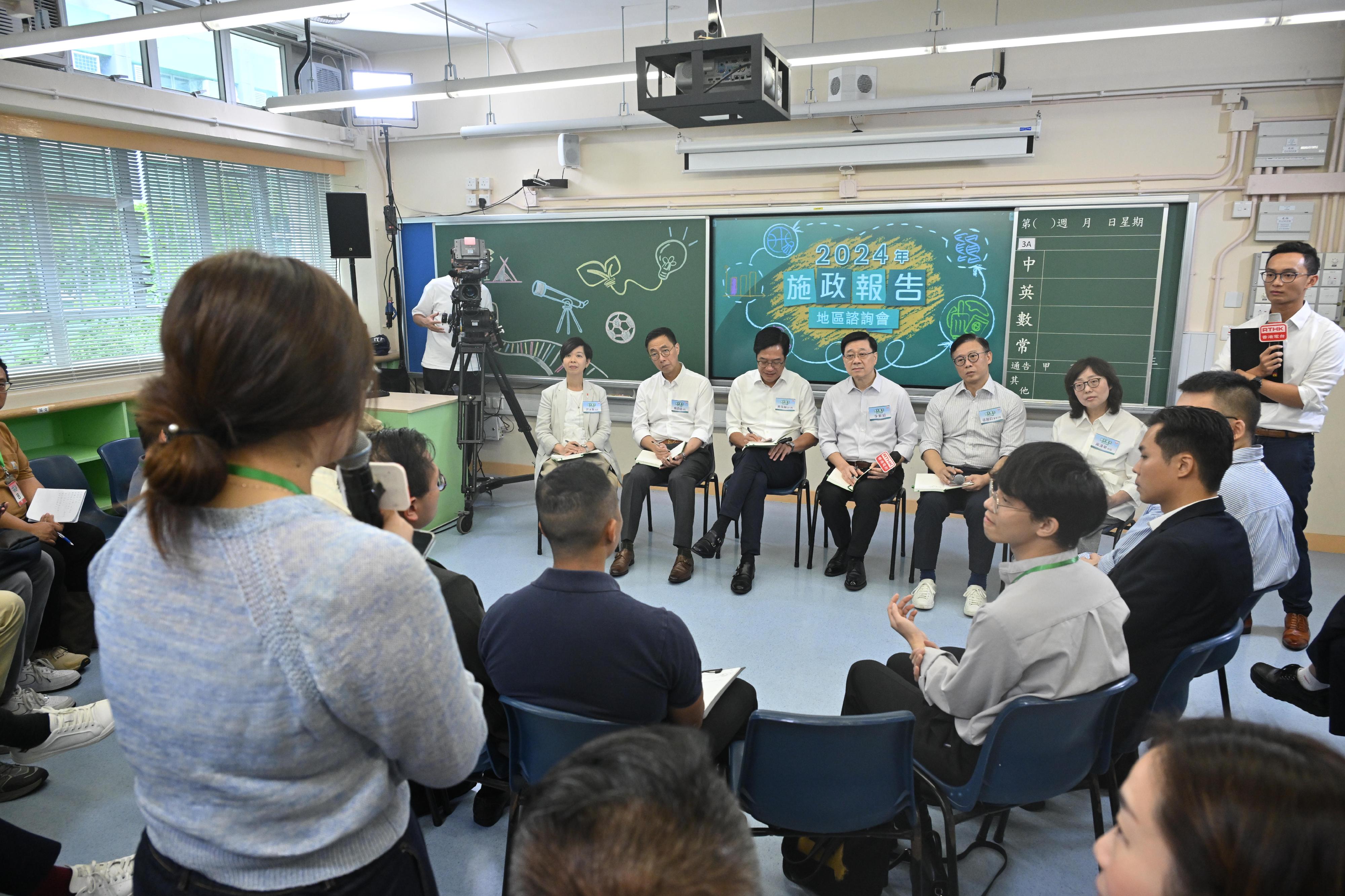 The Chief Executive, Mr John Lee, attended the 2024 Policy Address District Forum with some Principal Officials this morning (August 18) to listen to views and suggestions of local community members on the upcoming Policy Address. Photo shows (from left) the Secretary for Housing, Ms Winnie Ho; the Secretary for Culture, Sports and Tourism, Mr Kevin Yeung; the Deputy Financial Secretary, Mr Michael Wong; Mr Lee; the Acting Secretary for Justice, Mr Cheung Kwok-kwan; and the Secretary for Development, Ms Bernadette Linn, listening to views of the public at the consultation session.