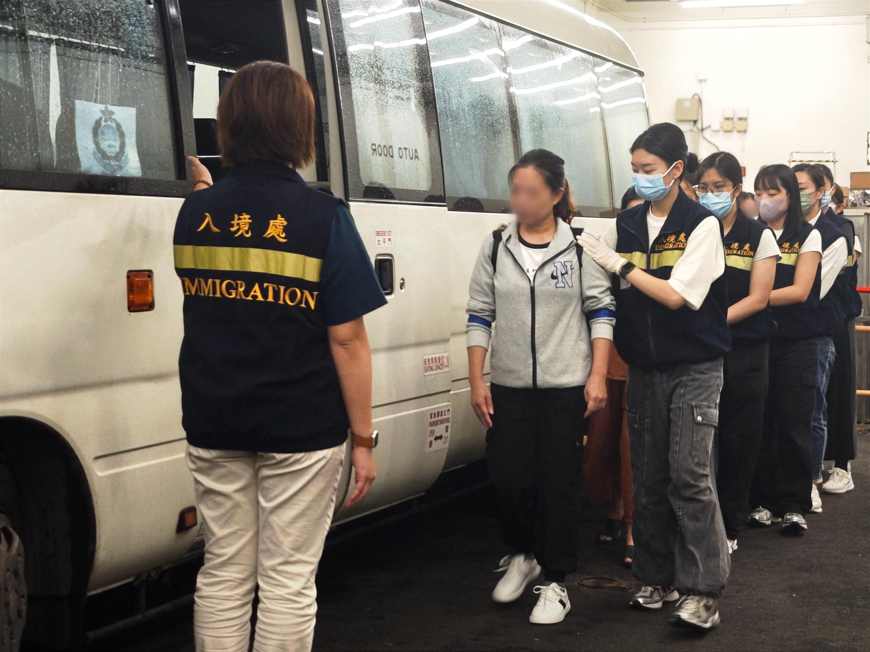 The Immigration Department (ImmD) carried out a repatriation operation today (August 21).  A total of 22 Vietnamese illegal immigrants were repatriated to Vietnam.  Photo shows removees being escorted by ImmD officers to proceed to the airport from the detention place.