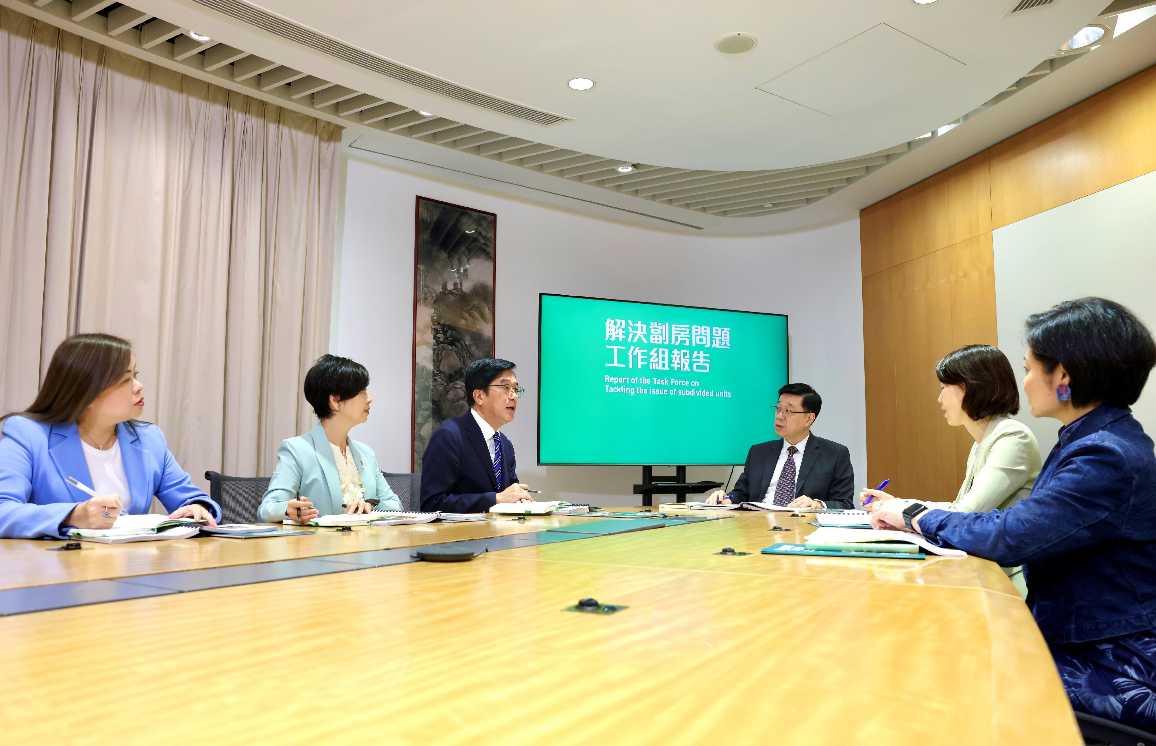 The Deputy Financial Secretary, Mr Michael Wong (third left), being the Head of the Task Force on Tackling the Issue of Subdivided Units, along with the Secretary for Housing, Ms Winnie Ho (second left), being the Deputy Head, and the Permanent Secretary for Housing/Director of Housing, Miss Rosanna Law (first left), being a member of the Task Force, submitted today (August 22) the Task Force's report to the Chief Executive, Mr John Lee (third right), presenting findings of the in-depth study conducted over the past 10 months with detailed recommendations for the comprehensive and orderly handling of the issue of substandard subdivided units. The Director of the Chief Executive's Office, Ms Carol Yip (second right), and the Private Secretary to the Chief Executive, Mrs Vicki Kwok (first right), are also present.