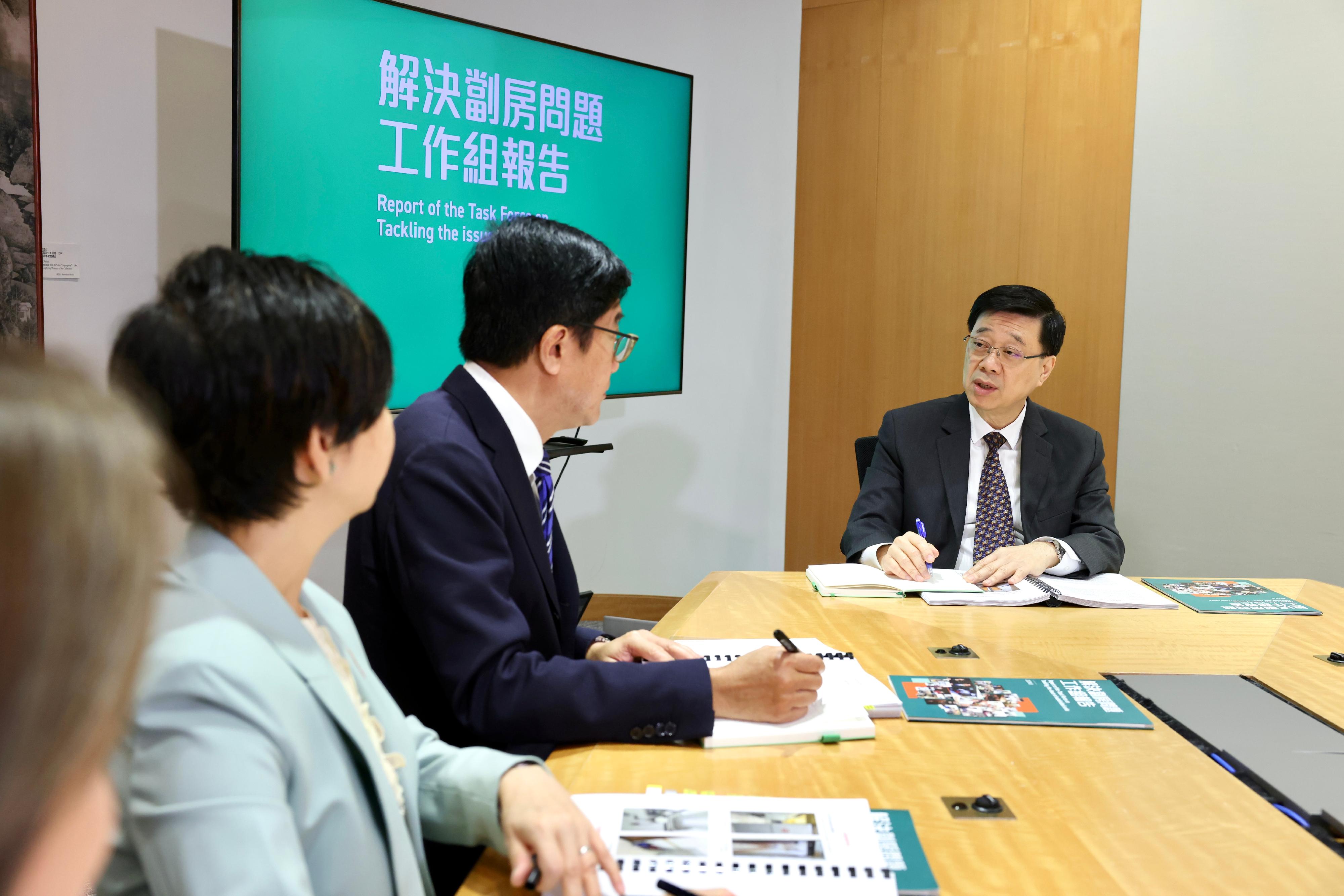 The Deputy Financial Secretary, Mr Michael Wong (centre), being the Head of the Task Force on Tackling the Issue of Subdivided Units, along with the Secretary for Housing, Ms Winnie Ho (left), being the Deputy Head, submitted today (August 22) the Task Force's report to the Chief Executive, Mr John Lee (right), presenting findings of the in-depth study conducted over the past 10 months with detailed recommendations for the comprehensive and orderly handling of the issue of substandard subdivided units. 