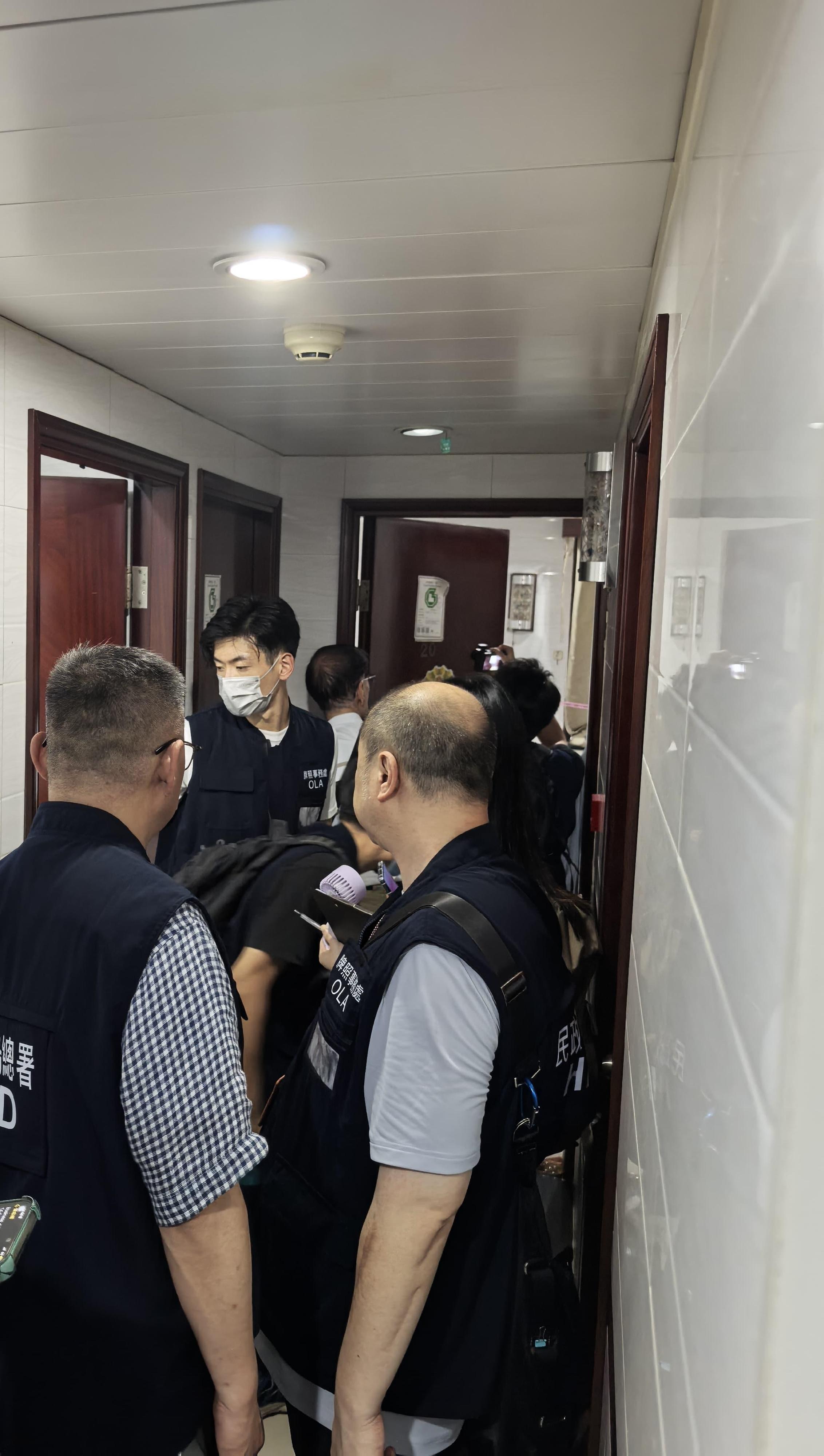 The Office of the Licensing Authority (OLA) of the Home Affairs Department conducted an operation codenamed "Star Catcher" from August 9 to 21 to inspect premises in Yau Tsim Mong, which were suspected of operating unlicensed guesthouses, and inspected licensed guesthouses. Photo shows OLA enforcement officers conducting inspections in a licensed guesthouse.