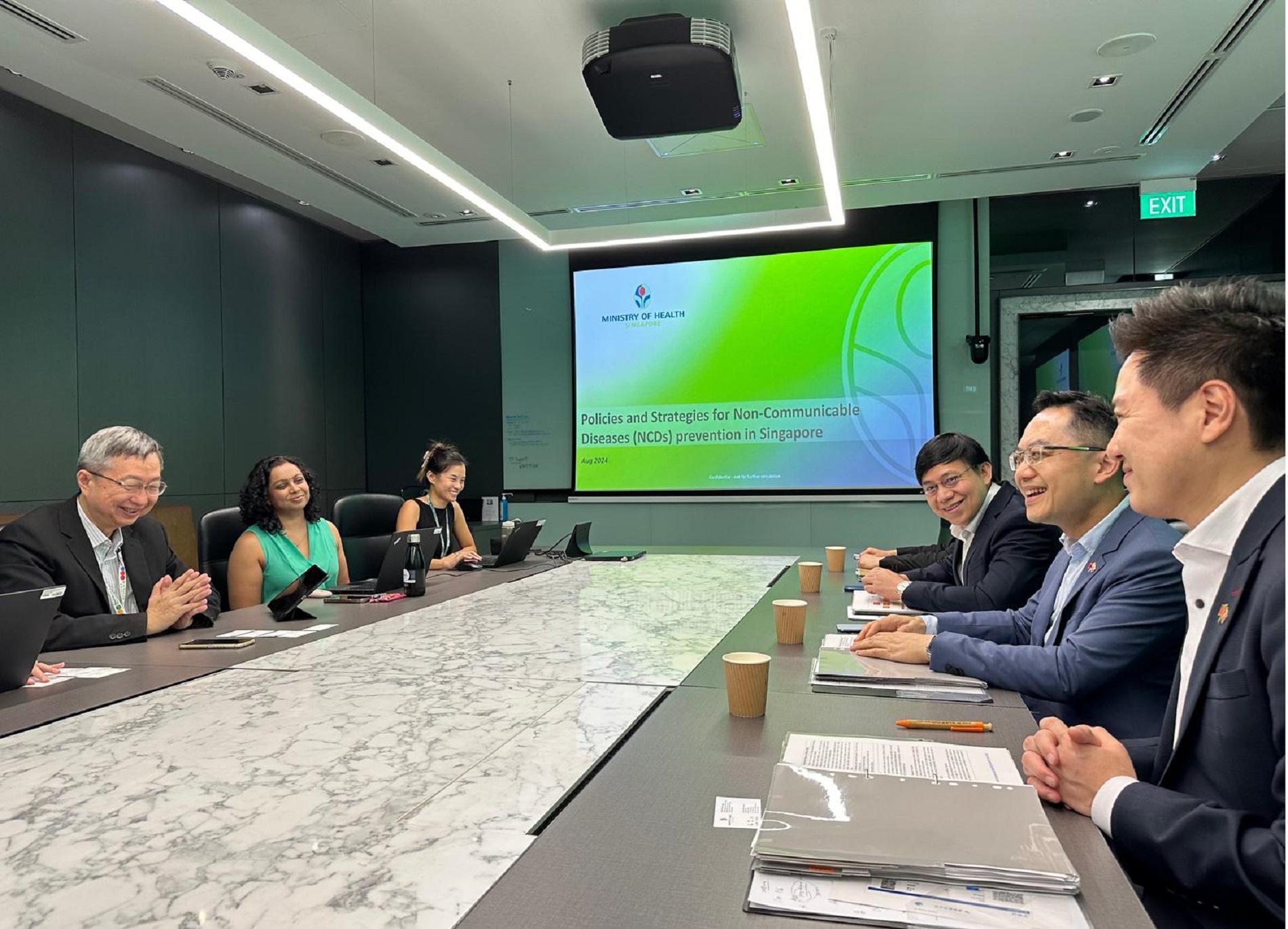 The Director of Health, Dr Ronald Lam, led a delegation from the Centre for Health Protection (CHP) of the Department of Health to Singapore and started a three-day visit on August 22. Photo shows Dr Lam (second right) and the Controller of the CHP, Dr Edwin Tsui (first right), having a meeting with the Ministry of Health of Singapore to gain a better understanding of strategies on non-communicable diseases prevention including tobacco control and cancer screening in Singapore.