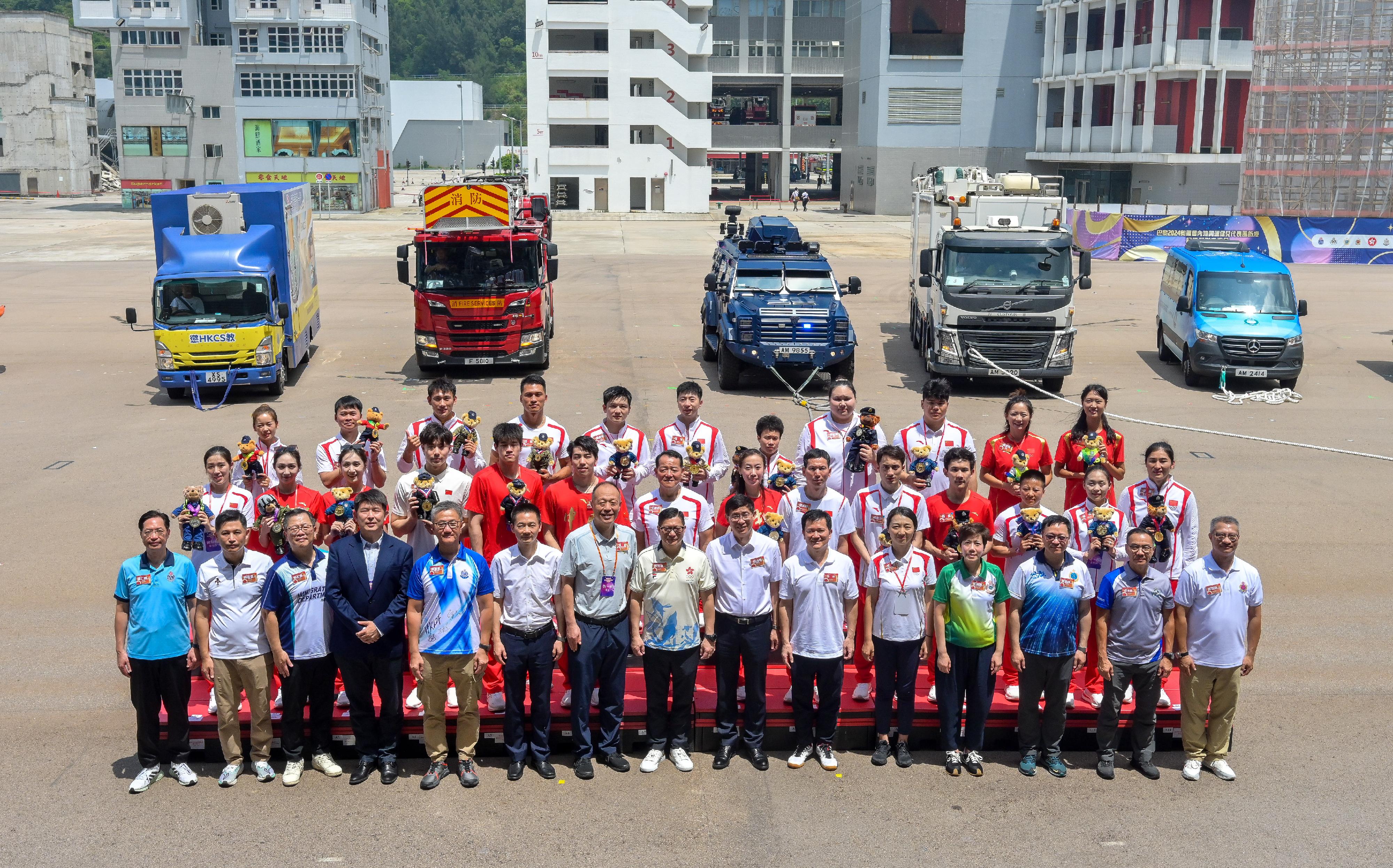 The delegation of the 2024 Paris Olympic Games Mainland Olympians arrived in Hong Kong yesterday (August 29) for a three-day visit. Twenty-nine people, including 22 athletes and three coaches, from the delegation met with members of the disciplined services and auxiliary services as well as their youth uniformed groups to share in the joy of the Olympians' achievements and give sports demonstrations at the Fire and Ambulance Services Academy this morning (August 30). Photo shows the Secretary for Security, Mr Tang Ping-keung (front row, centre), heads of disciplined services and auxiliary services, and the attending delegation members.