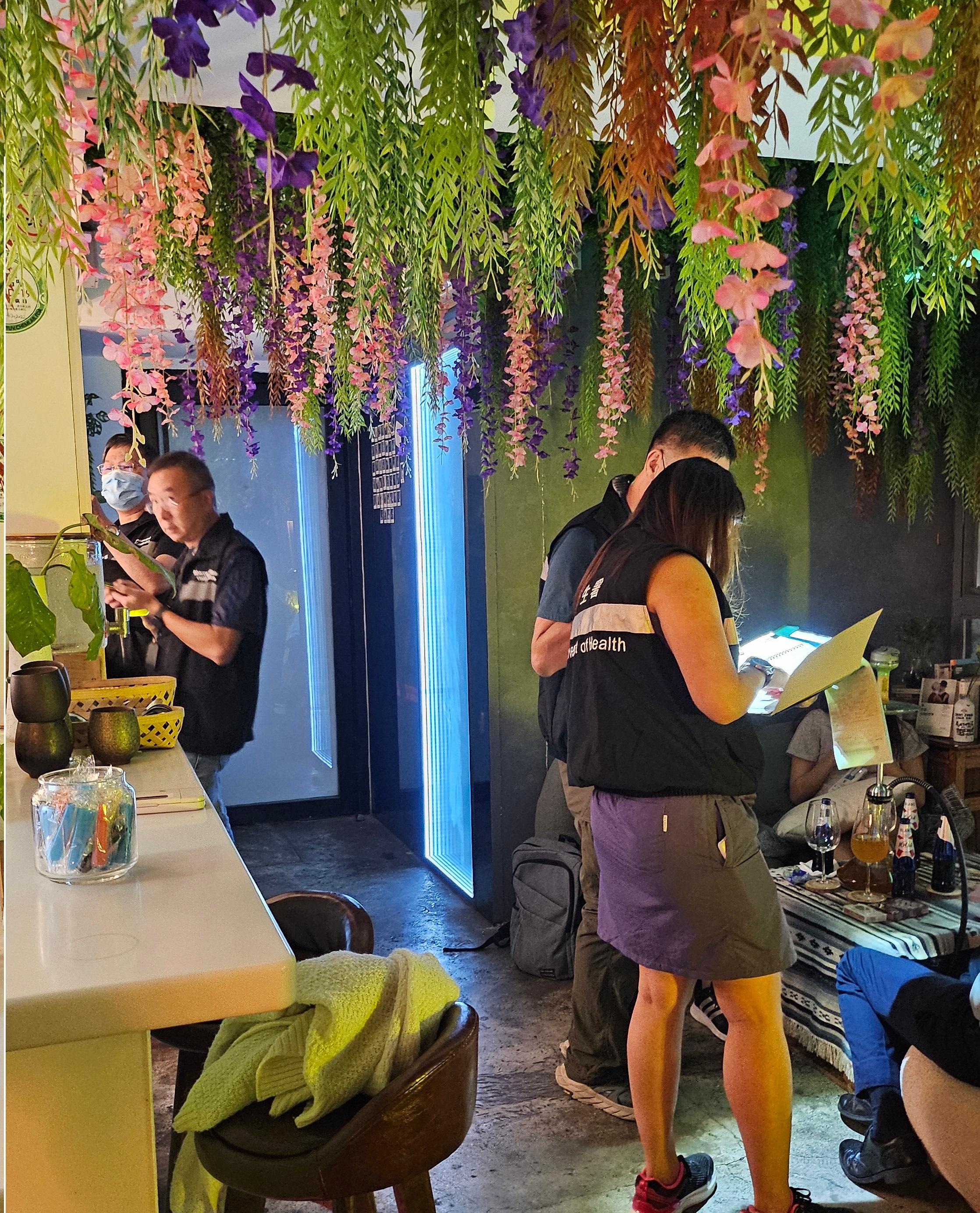 The Tobacco and Alcohol Control Office (TACO) of the Department of Health conducted an enforcement operation against illegal waterpipe smoking activities in no smoking areas in Central District last night (September 3). Photo shows officers from TACO taking enforcement action inside a bar.