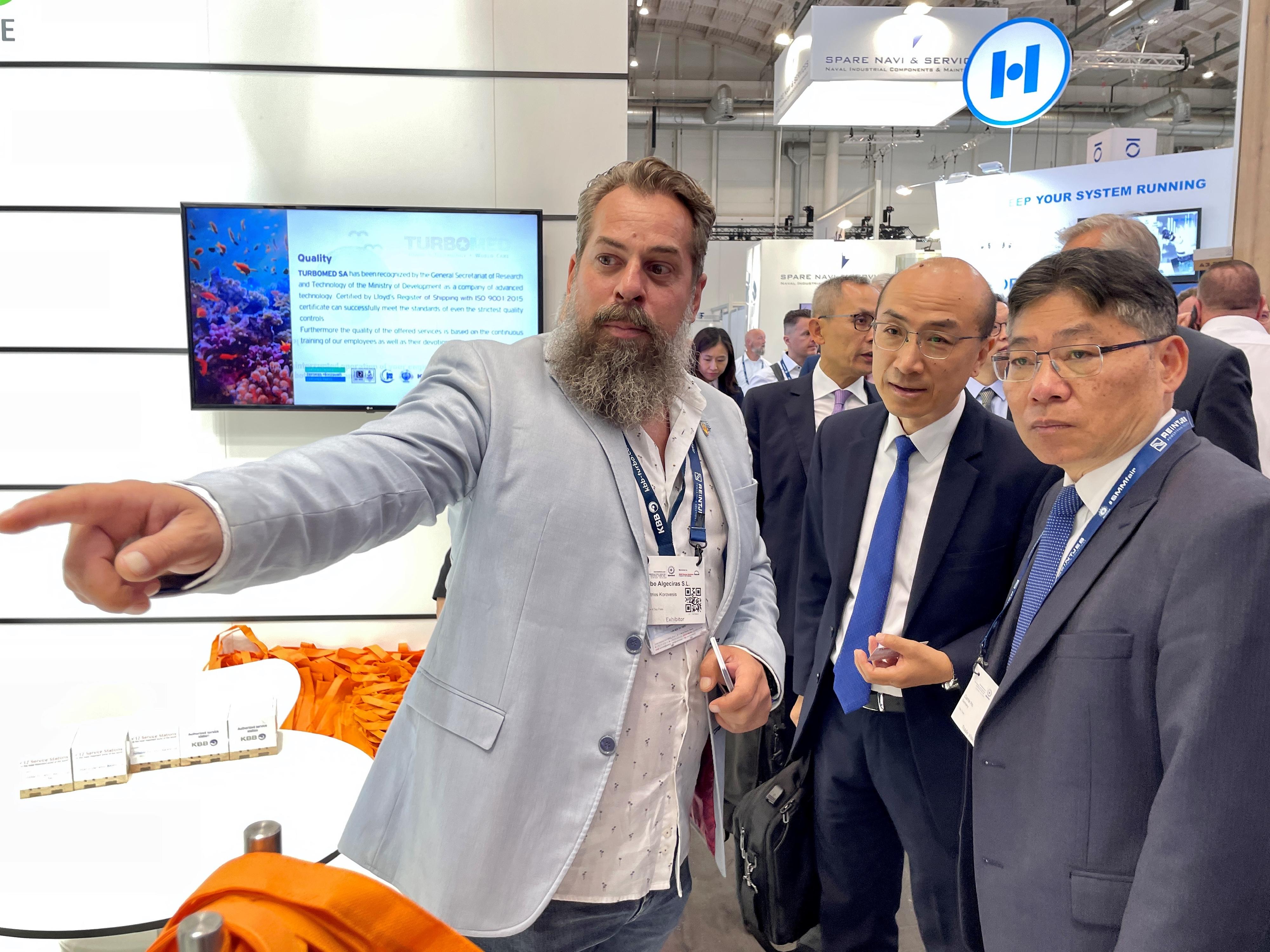 The Secretary for Transport and Logistics, Mr Lam Sai-hung, who is also the Chairman of the Hong Kong Maritime and Port Board (HKMPB), continued his visit to Hamburg, Germany, with a delegation of HKMPB members. Photo shows Mr Lam (first right) and Deputy Director of Marine Mr Shi Qiang (second right) receiving a briefing from an exhibitor representative on the latest maritime trend at the Shipbuilding, Machinery and Marine Technology (SMM) trade fair 2024 in Hamburg on September 4 (Hamburg time).