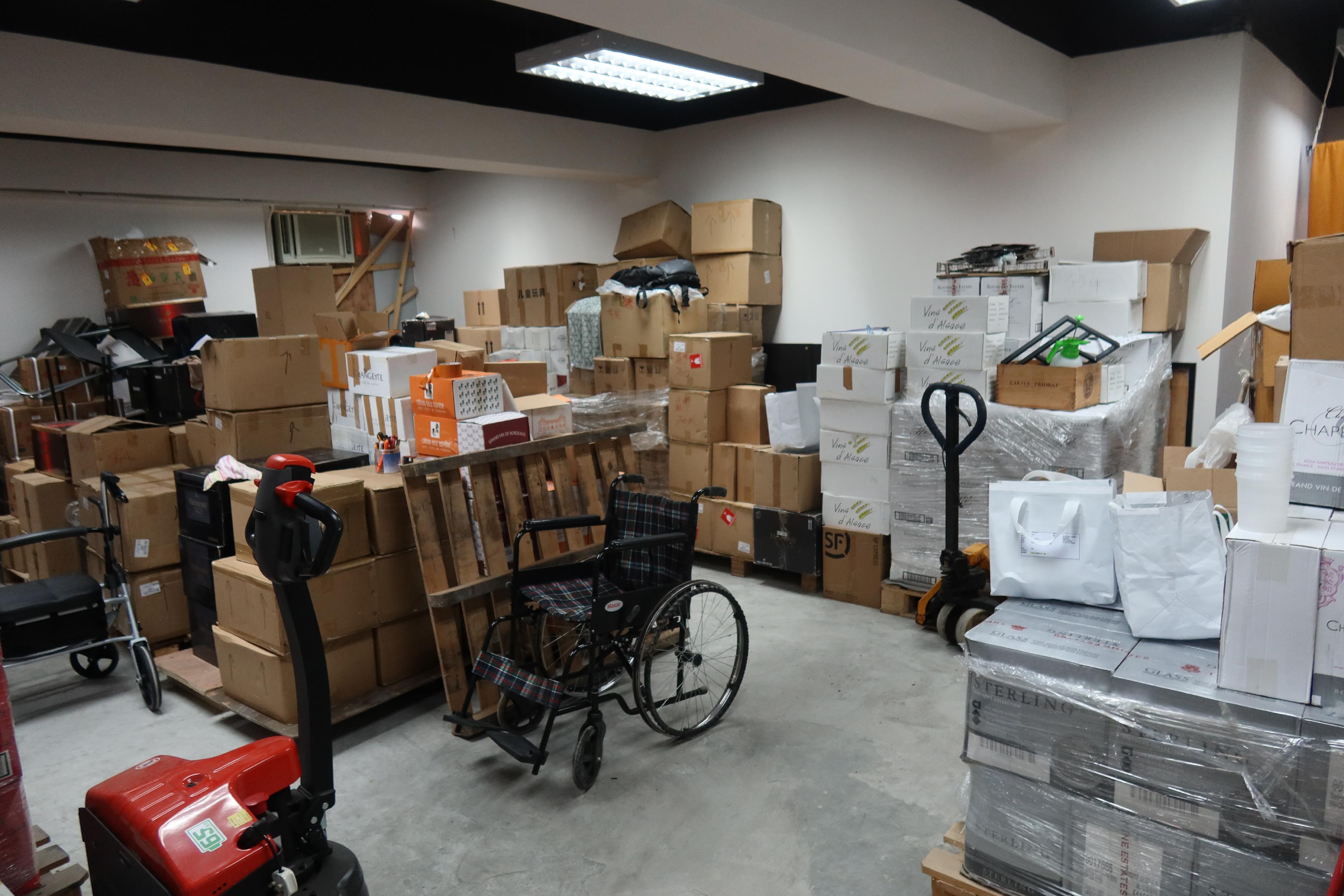 Hong Kong Customs on August 27 mounted a special enforcement operation in Kwai Chung to combat the sale of counterfeit liquor. A total of about 1 300 bottles of suspected counterfeit liquor, with an estimated market value of about $2.9 million, were seized. Photo shows the storage facility that stores suspected counterfeit liquor raided by Customs officers. 