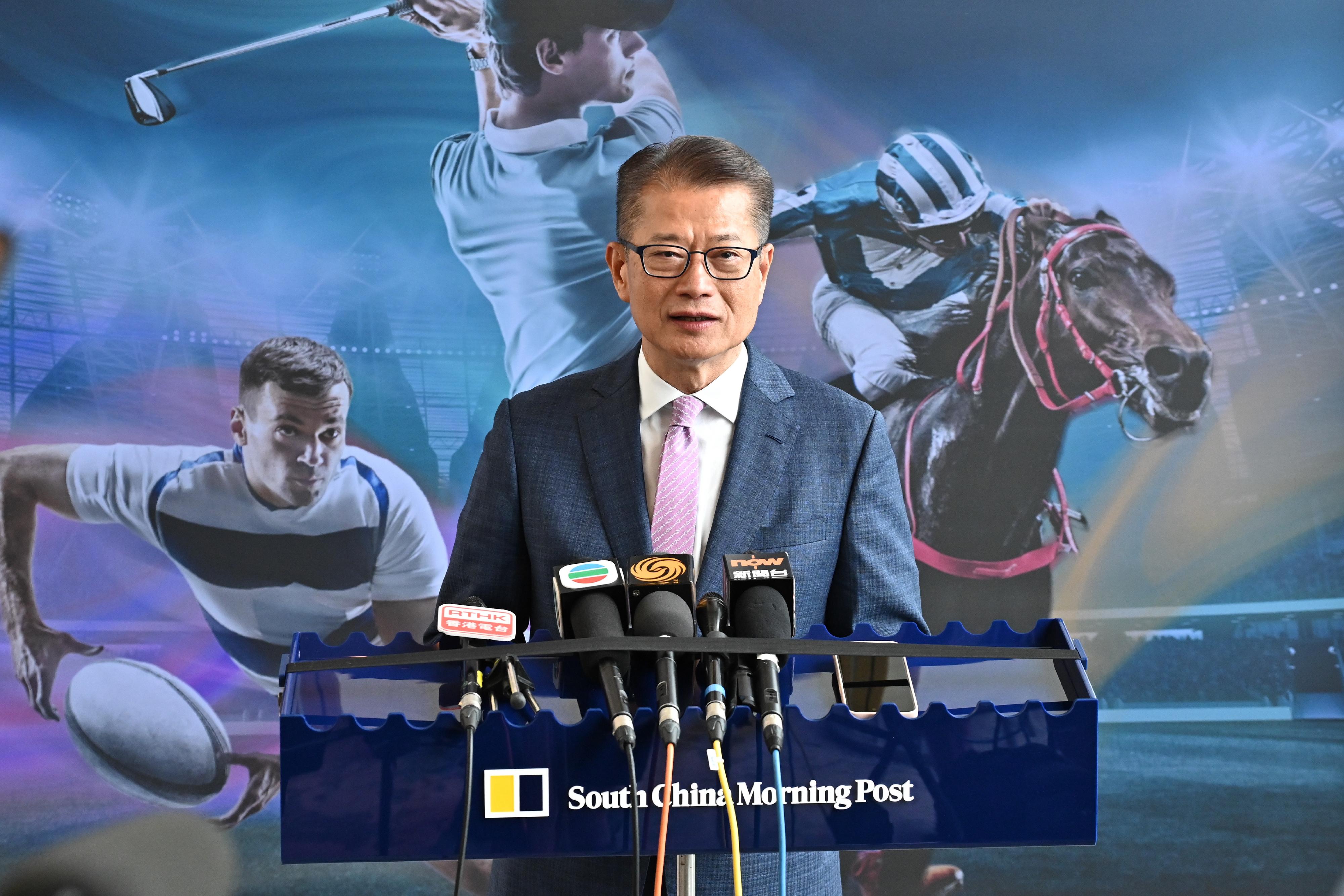 The Financial Secretary, Mr Paul Chan, meets the media after attending the Hong Kong Sports Economy & Tourism Summit organised by the South China Morning Post today (September 6).