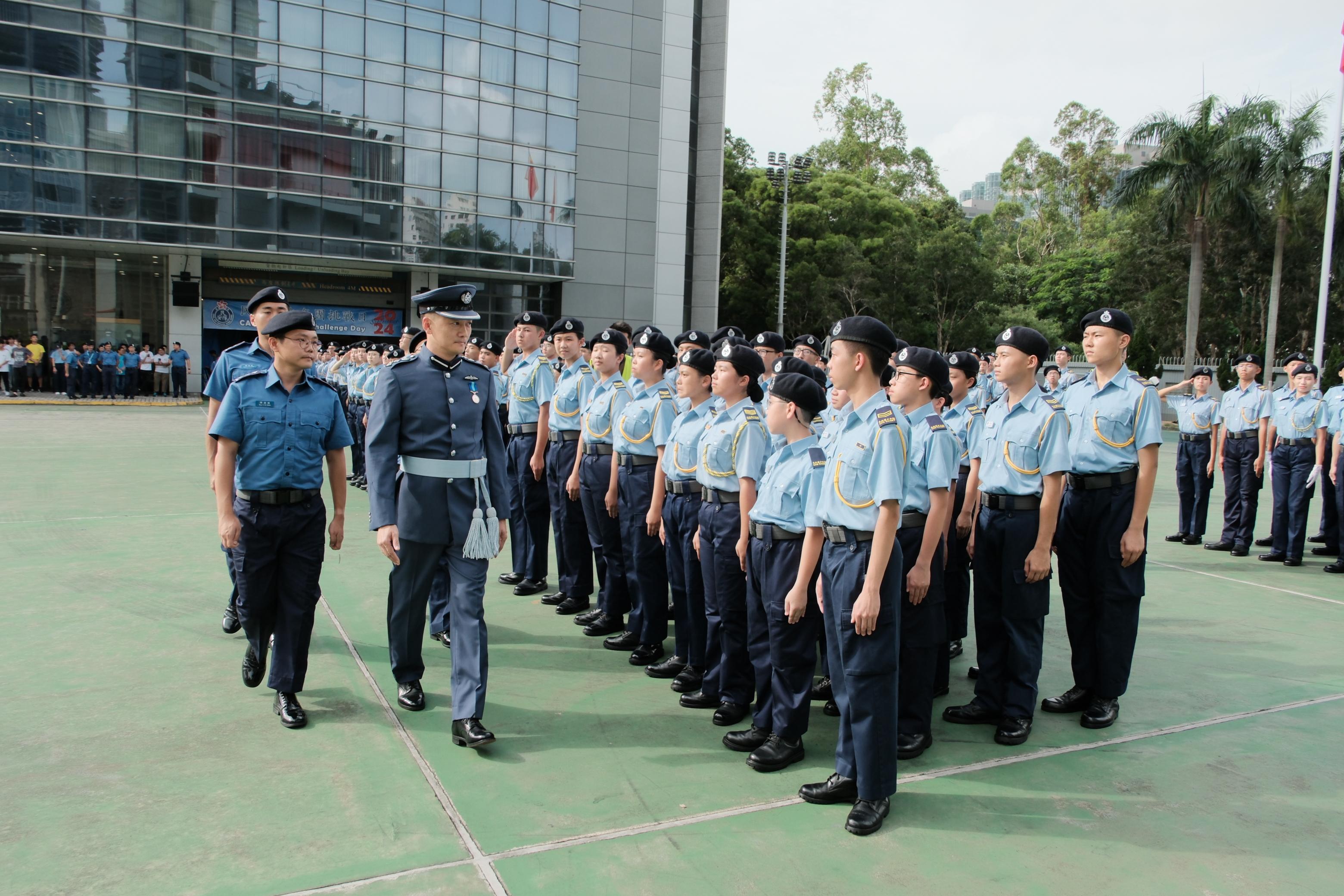 The Chief Pilot (Operations) of the Government Flying Service, Mr Eddie Liu (second left), reviews the teams participating in the Civil Aid Service Cadet Corps Challenge Day 2024 today (September 8).
